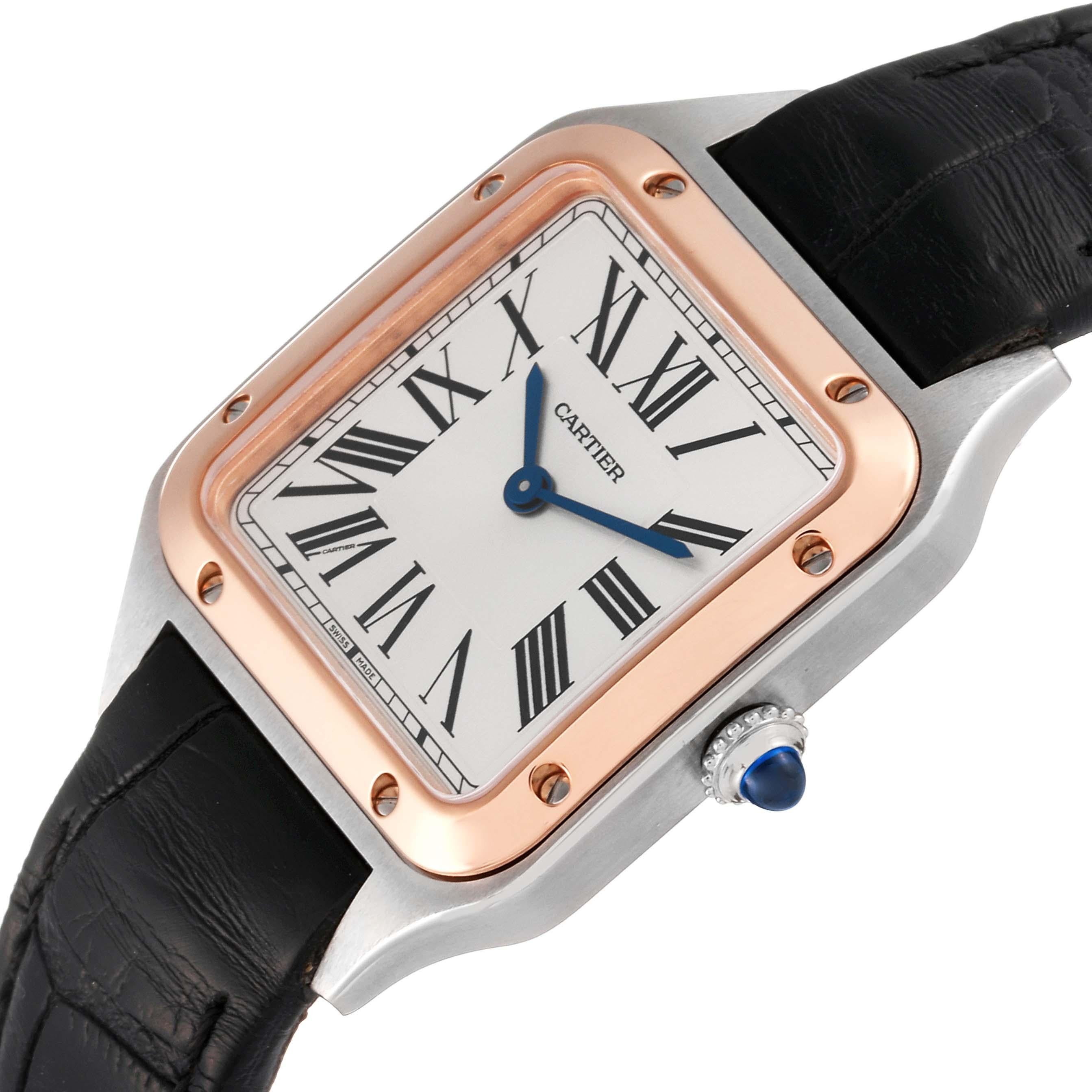 Cartier Santos Dumont Steel Rose Gold Silver Dial Ladies Watch W2SA0012. Quartz movement. Stainless steel case 38 mm x 27.5 mm. Case thickness 7.3 mm. Circular grained crown set with blue spinel cabochon. 18k rose gold bezel punctuated with 8