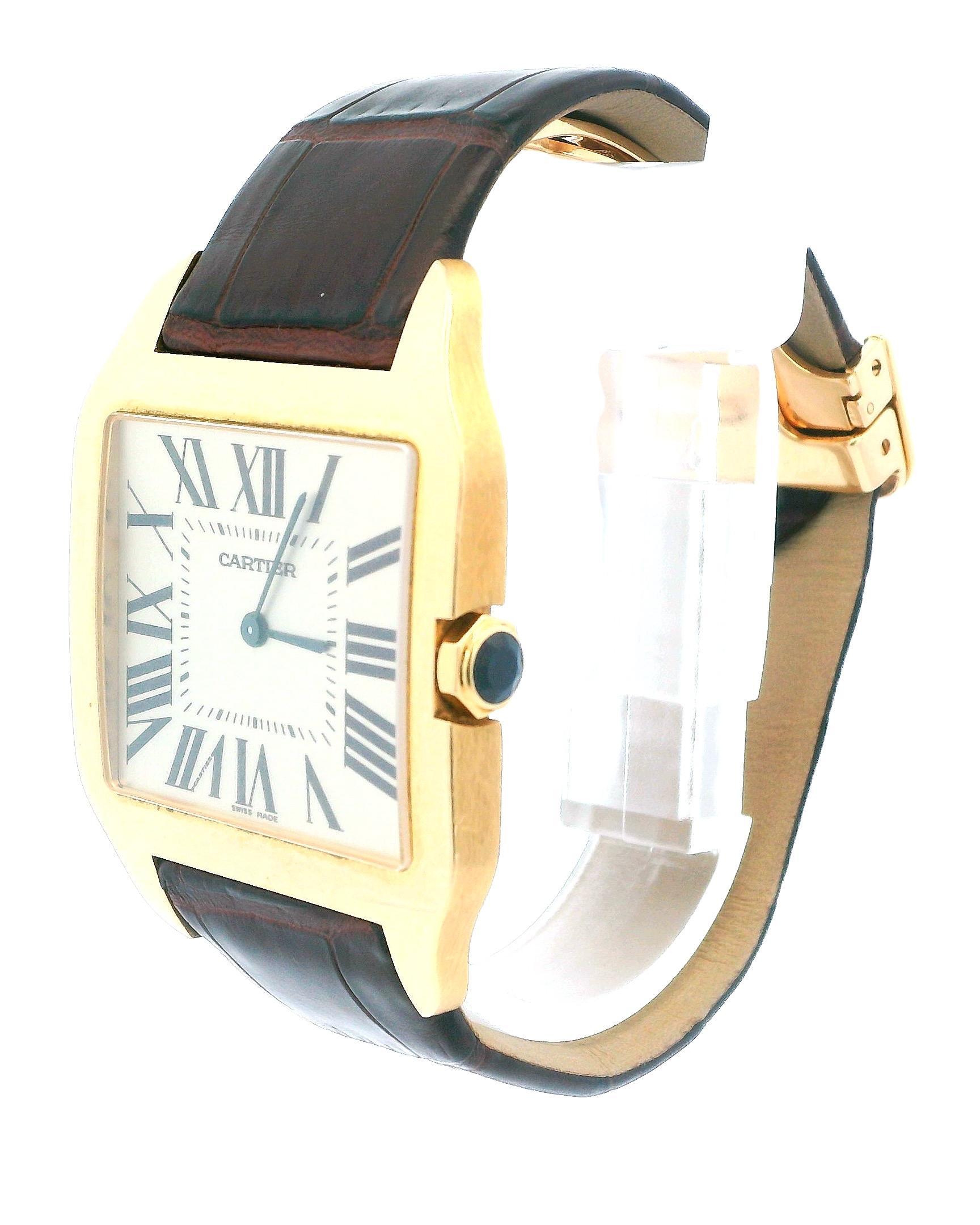 Cartier Santos Dumont 2649 watch. 35mm 18K yellow gold case. Silver dial with blue hands and black Roman numeral hour marker. Minute markers on the inner dial. Brown leather strap with 18K yellow gold deployment clasp. Will fit up to 6-Inch wrist.