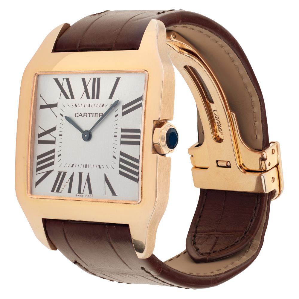 Cartier Santos Dumont in 18k rose gold on leather strap with Cartier 18k deployant buckle. Manual. 35 mm x 32 mm case size. Ref W2008751. Fine Pre-owned Cartier Watch. Certified preowned Classic Cartier Santos Dumont W2008751 watch on a Brown