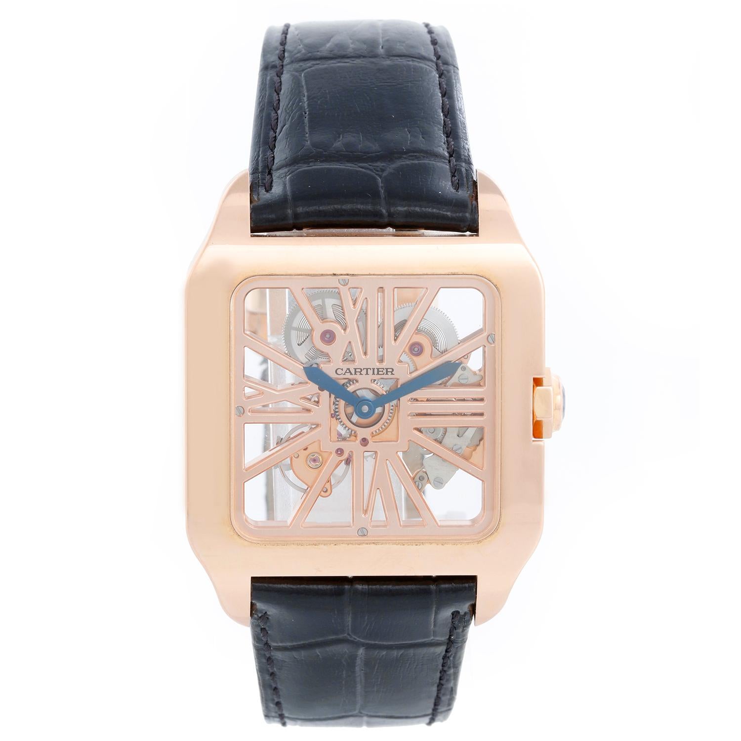 Cartier Santos Dumont XL Skeleton Rose Gold Watch W2020057 - Manual. 18K Rose Gold with sapphire crown ( 38 mm x 47 mm ). Skeleton complication of bridges in the form of Roman numerals. Black Cartier bracelet with Cartier gold deployant clasp.