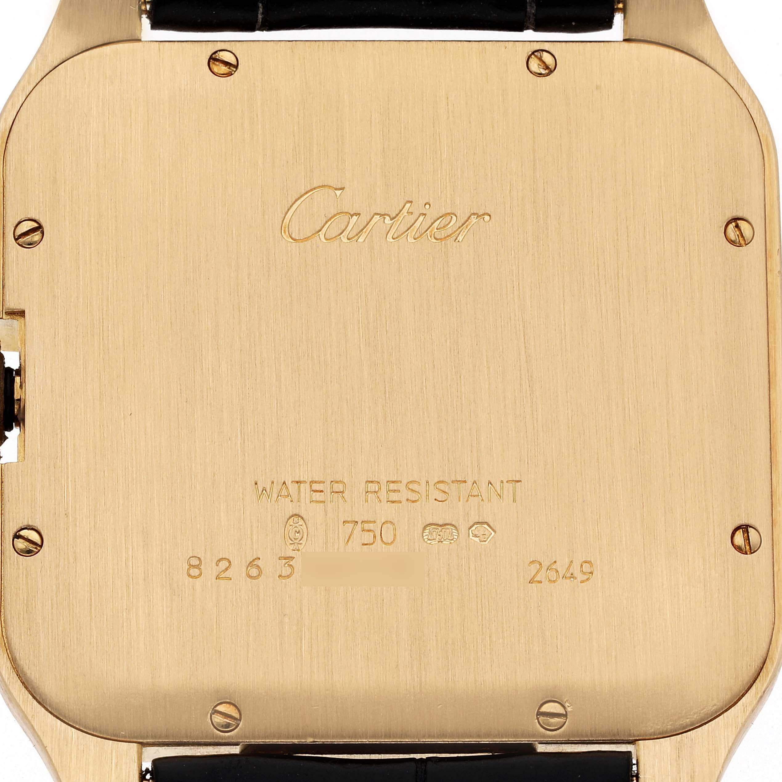 Cartier Santos Dumont Yellow Gold Mens Watch W2008751. Manual winding movement. 18K yellow gold case 44.6 x 34.6mm.  Octagonal crown set with faceted blue sapphire. 18K yellow gold bezel. Scratch resistant sapphire crystal. Silver dial with radial