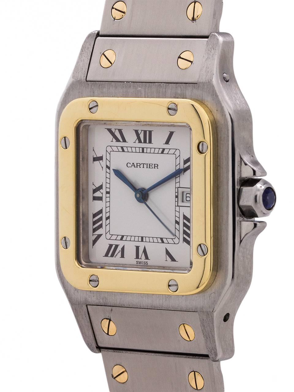 
Cartier Santos Galbee Stainless Steel and 18K Yellow Gold circa 2000s. 30mm diameter case with yellow gold screwed in bezel and case back secured by 8 screws. Sapphire crystal and signature blue cabochon sapphire crown. Classic white dial with