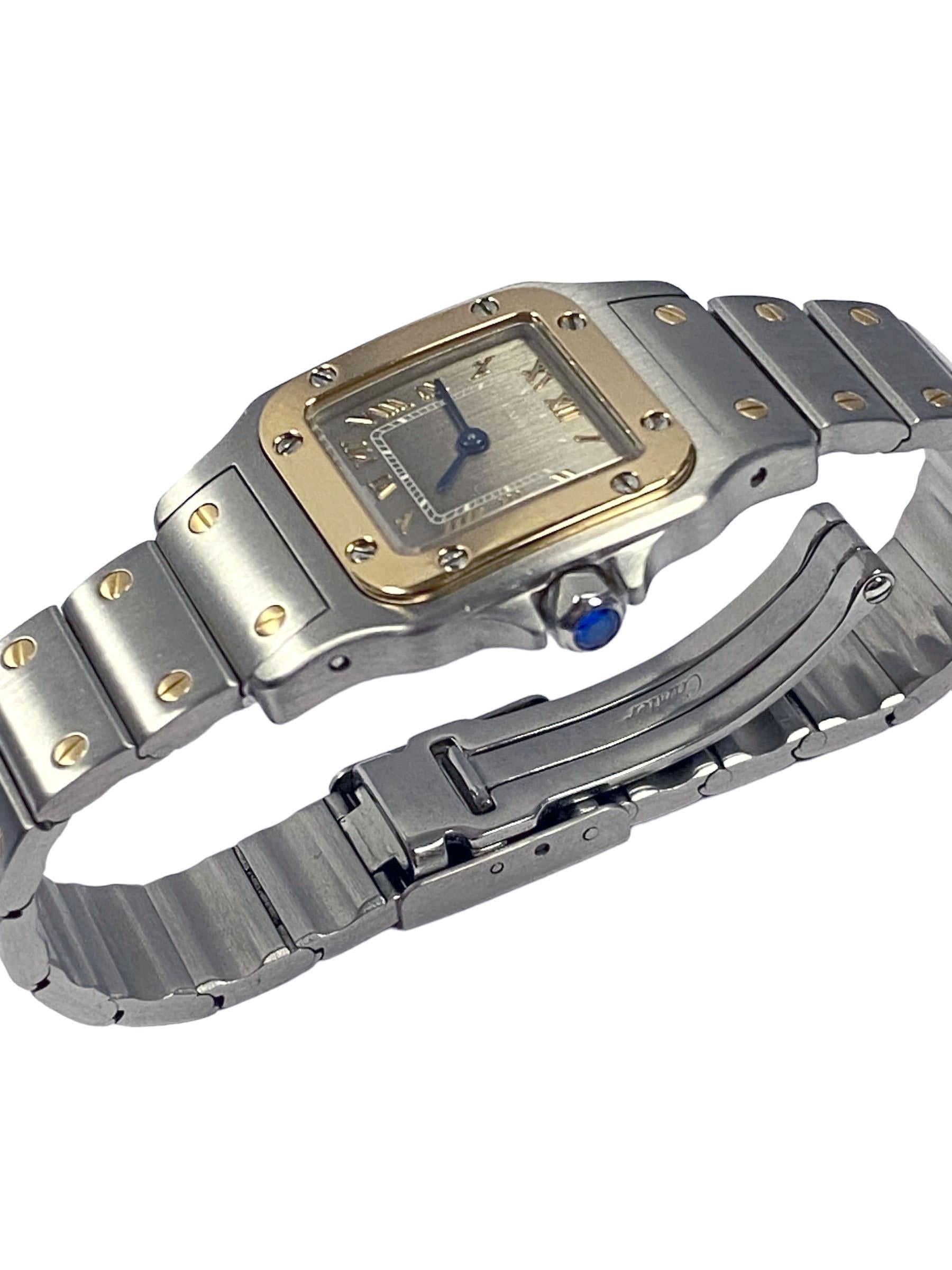 Circa 2005 Cartier Santos Galbee Ladies Wrist Watch, 34 X 24 MM Stainless Steel case with 18K Yellow Gold Bezel. Quartz movement, Silver Dial with raised Gold markers, sapphire crown. 1/2 inch wide Stainless Steel and 18K Yellow Gold Santos Bracelet