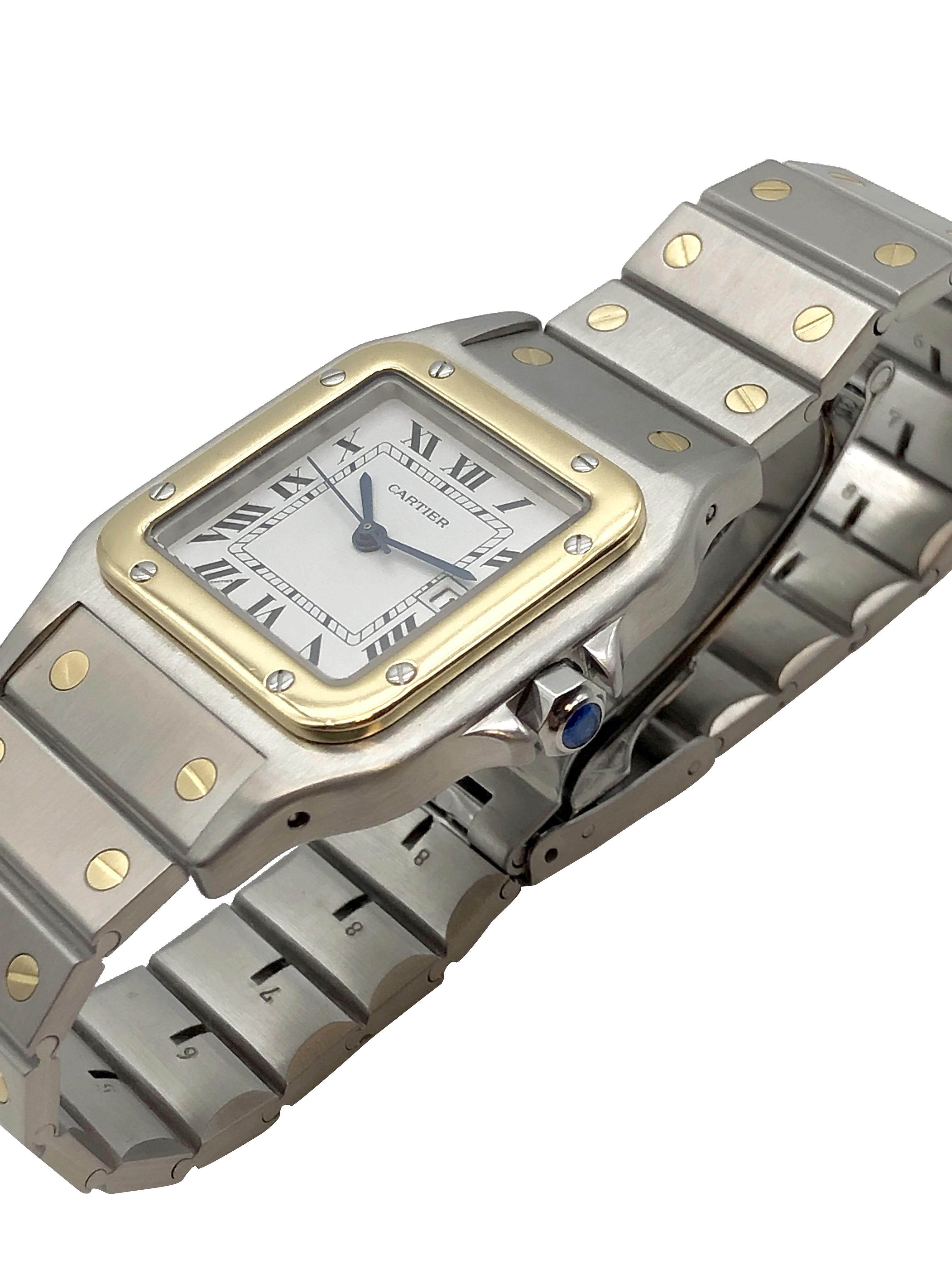 Circa 2000 Cartier Santos Galbee Wrist Watch 41 M.M. ( lug end to end ) X 29 M.M Stainless Steel case with 18K Yellow Gold Bezel and a Sapphire Crown, Quartz Movement, White Dial with Black Roman Numerals a Calendar window at the 3 position and a