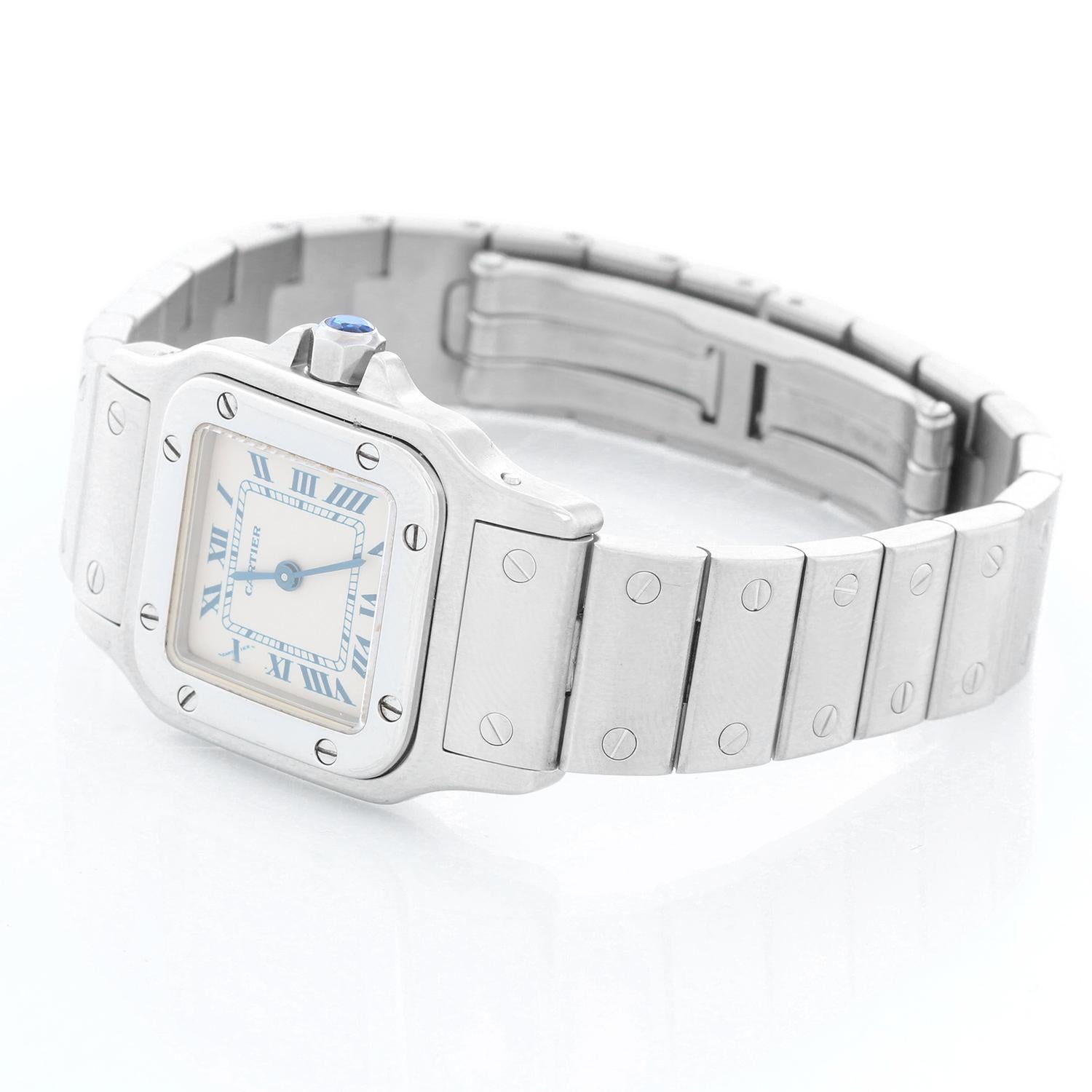 Cartier Santos Galbee Small Ladies Watch 1565 - Quartz. Stainless steel case (24mm x 35mm). Ivory dial with blue Roman numerals. Stainless steel Santos bracelet; will fit a 6 3/4 inch wrist . Pre-owned with custom box. 