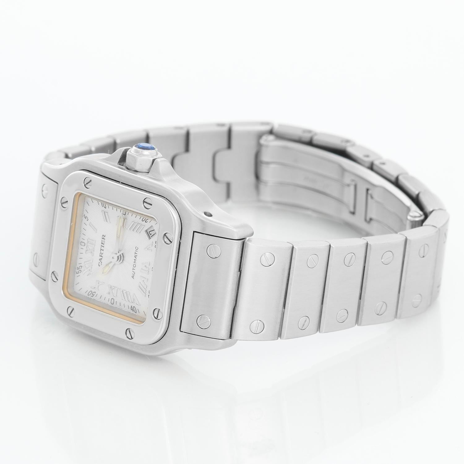 Cartier Santos Galbee Small Ladies Watch 2423 - Automatic. Stainless steel case (24mm x 35mm). White dial with steel Roman numerals; date between 3 & 4 o'clock. Stainless steel Santos bracelet. Pre-owned with custom box.