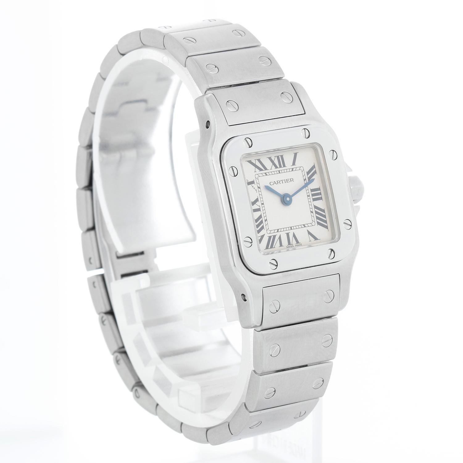 Cartier Santos Galbee Small Ladies Watch Roman Numerals 1565 W20056D6 - Quartz. Stainless steel case (24mm x 35mm). Cream dial with steel roman numerals. Stainless steel Santos bracelet; will fit a 6 1/2 inch wrist. Pre-owned with custom box.