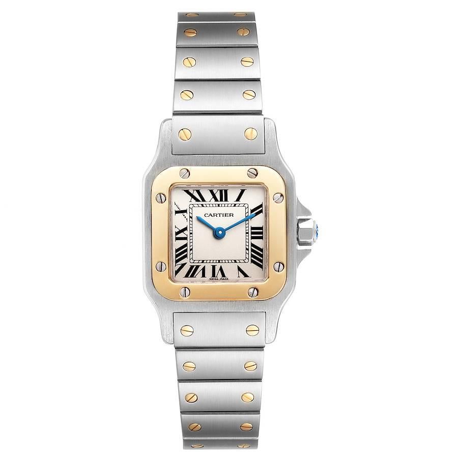 Cartier Santos Galbee Steel Yellow Gold Ladies Watch W20012C4. Quartz movement. Stainless steel case 24.0 x 34.7 mm. Steel octagonal crown set with a faceted blue spinel. . Scratch resistant sapphire crystal. Silver dial with black Roman numerals.