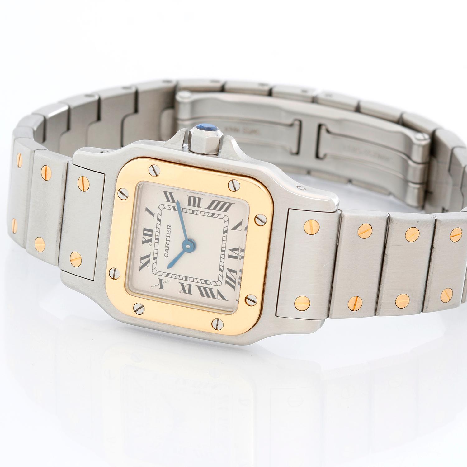 Cartier Santos Ladies 24mm Steel & Gold 2-Tone Automatic Watch - Quartz. Stainless steel case with 18k yellow gold bezel (24mm x 34mm ). Stainless steel case with 18k yellow gold bezel (24mm x 34mm ). Stainless steel bracelet with gold accents (will