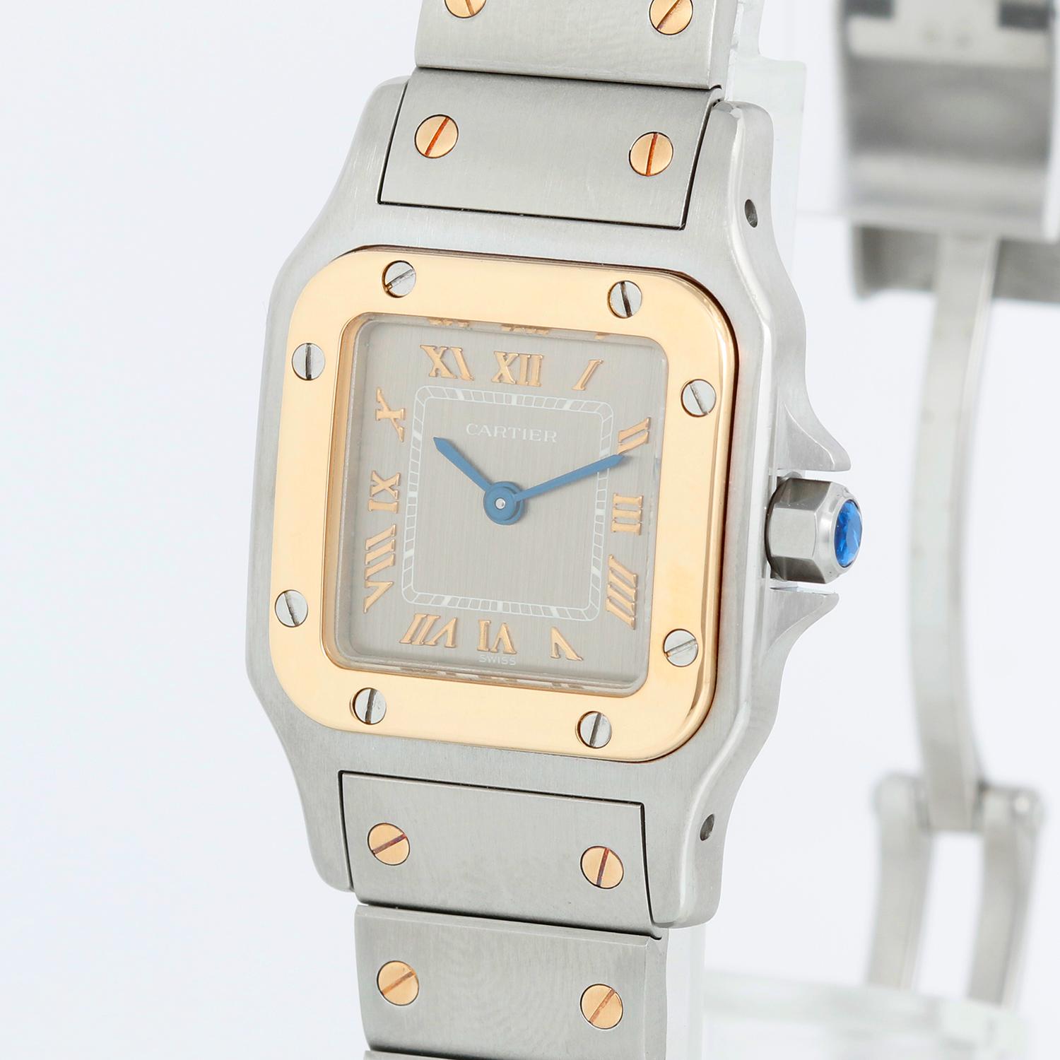 Cartier Santos Ladies 24mm Steel & Gold 2-Tone Watch 1567 - Quartz. Stainless steel case with 18k yellow gold bezel (24mm x 34mm ). Grey dial with gold Roman numerals. Stainless steel bracelet with gold accents ; will fit apx. 6 in. wrist. Pre-owned