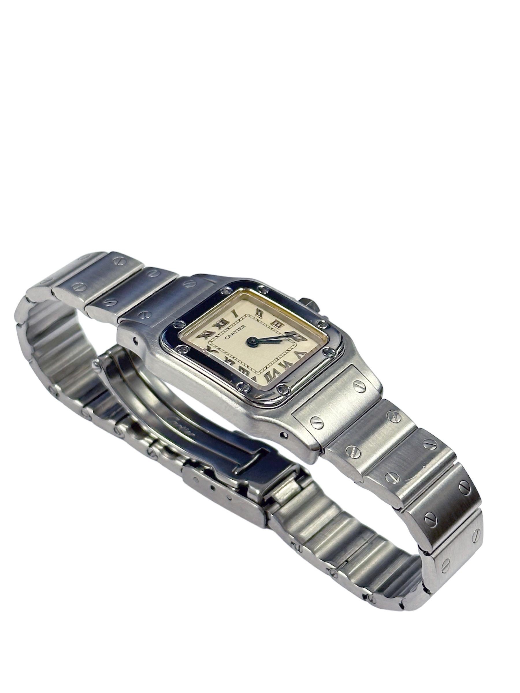 Circa 2000 Cartier Santos Ladies Wrist watch, 35 MM X 24 MM Stainless Steel Water Resistant case. Quartz Movement, Silver Dial  with Black Roman Numerals and a Sapphire Crown. 9/16 inch wide Stainless Steel, Santos Bracelet with Deployment buckle.