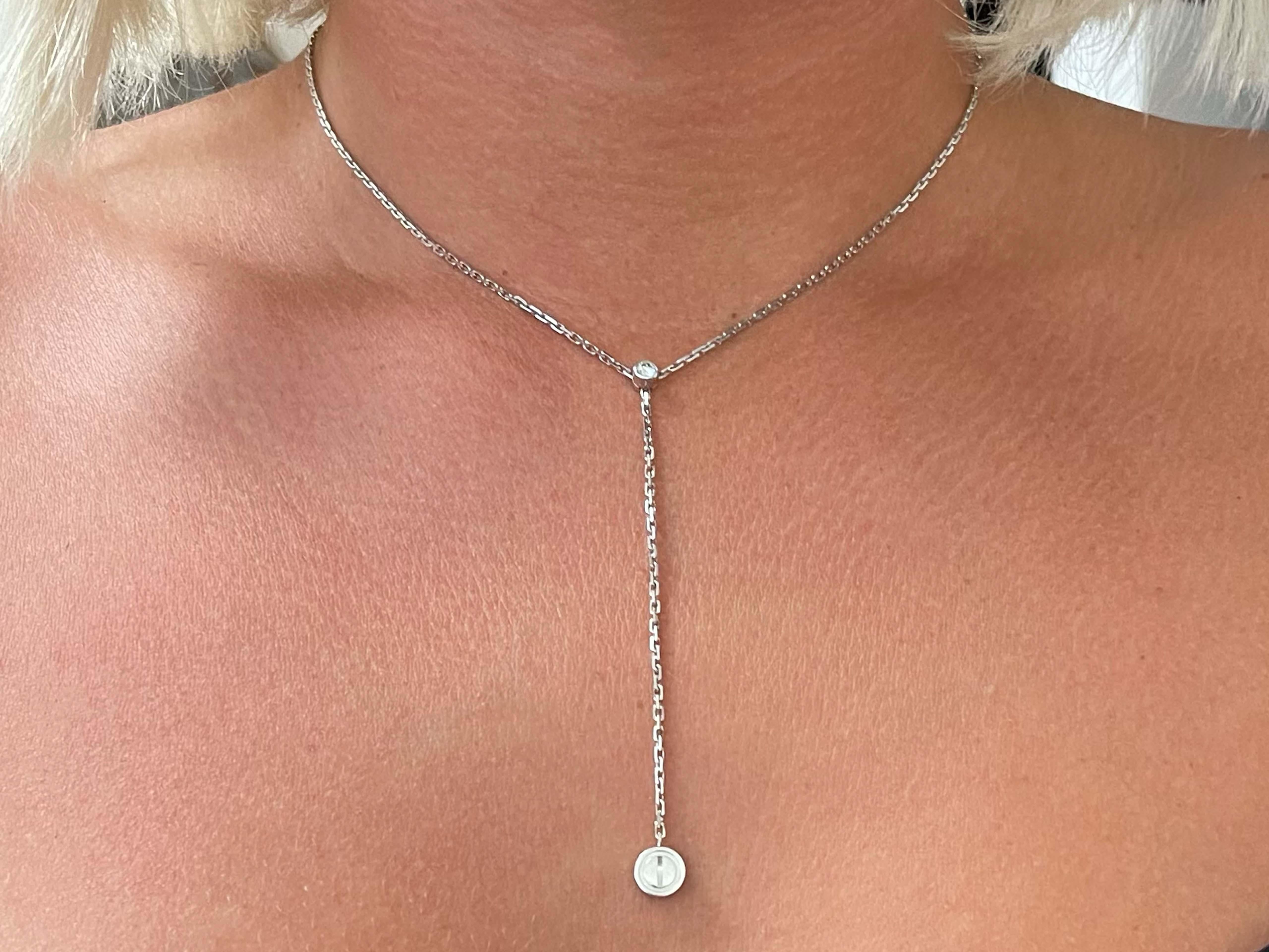 This Cartier Santos Love Diamond Drop Necklace in 18k White Gold features a round brilliant cut diamond D-F in color, VS in clarity weighing approx. 0.20 carats. The necklace is in 18k white gold and comes on a 14