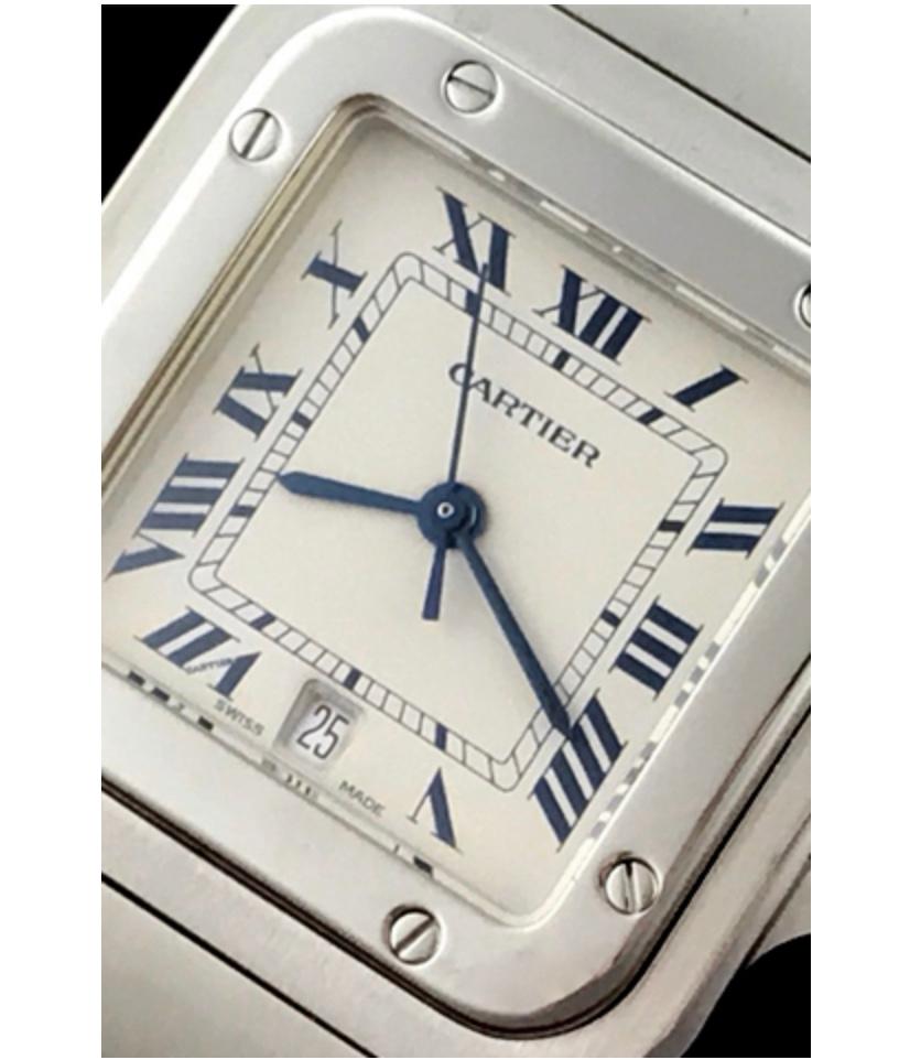 Charming and timeless. This beautiful Cartier Santos is in gorgeous condition. This watch features stainless steel construction. The dial is a silver textured dial that features black Roman numerals and date function. The stainless steel crown is