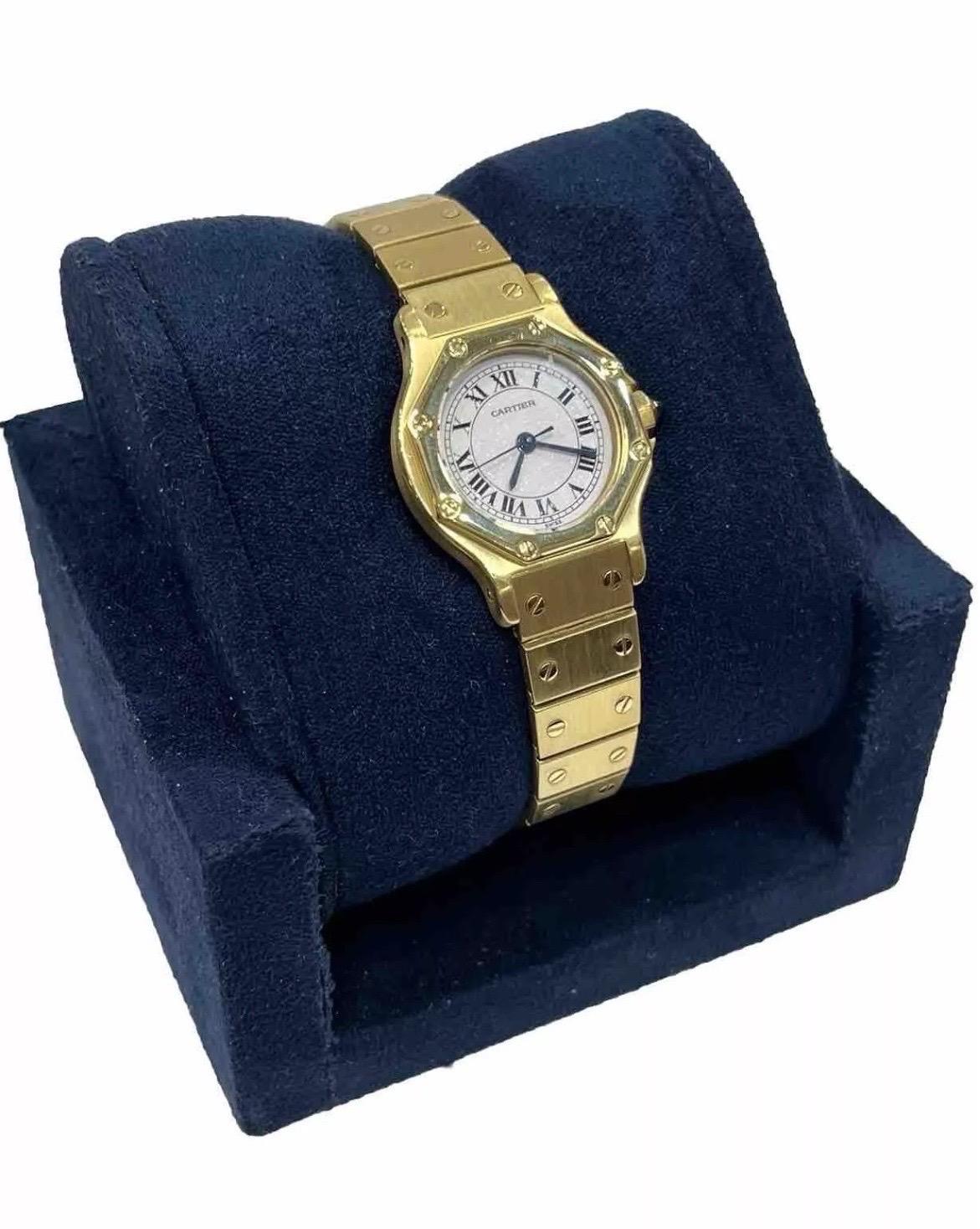 The Cartier Santos Octagon 0906 Yellow Gold Automatic White Dial Ladies Watch is a sophisticated blend of timeless design and precise functionality. Crafted in luxurious yellow gold, this 25mm timepiece features the iconic octagonal shape that has