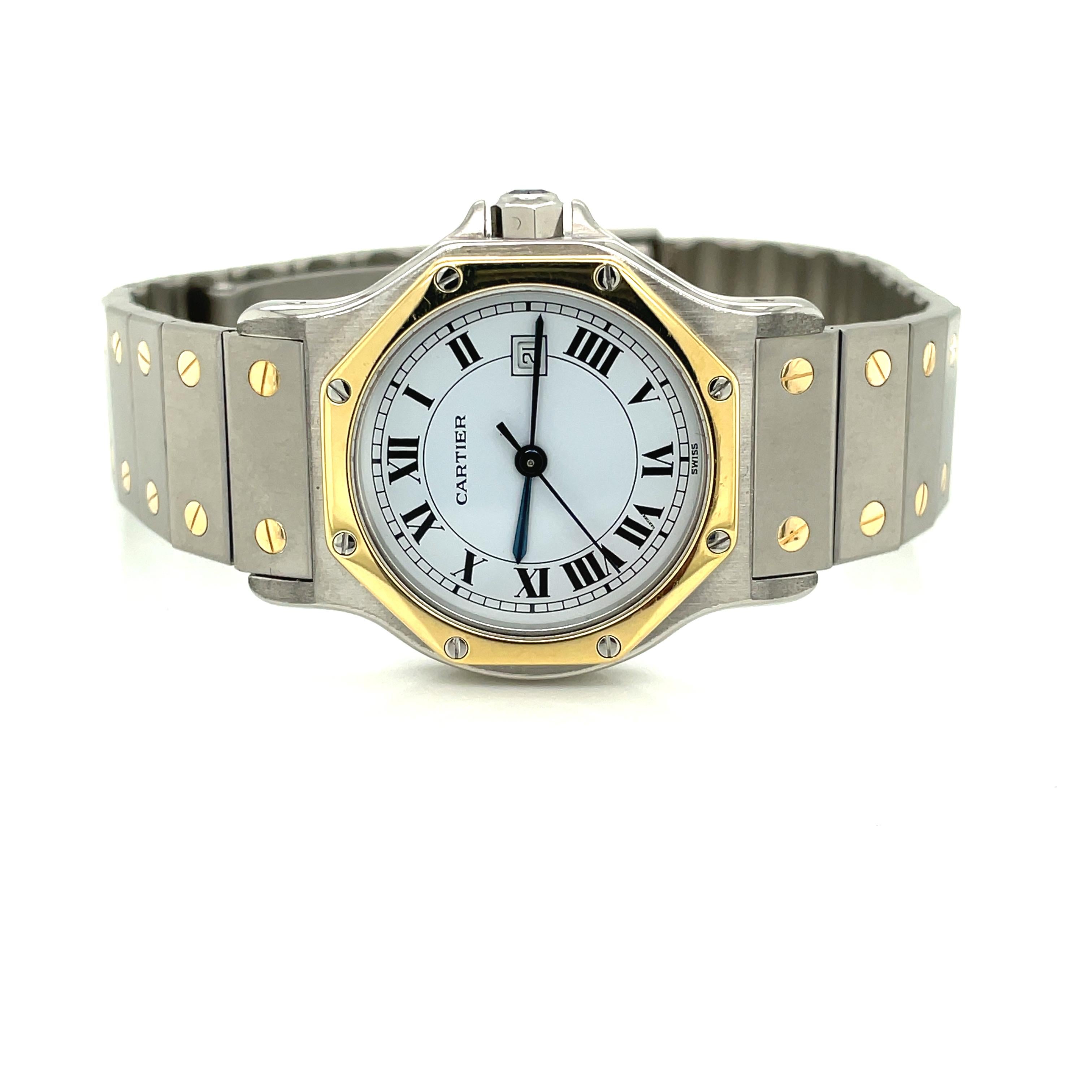 Versatile Cartier Santos Quartz Wrist Watch in satin stainless steel and 18 karat yellow gold with unisex styling. This popular octagon shaped timepiece with a 30mm steel case and 18 karat gold bezel features a white dial with Roman numeral hour