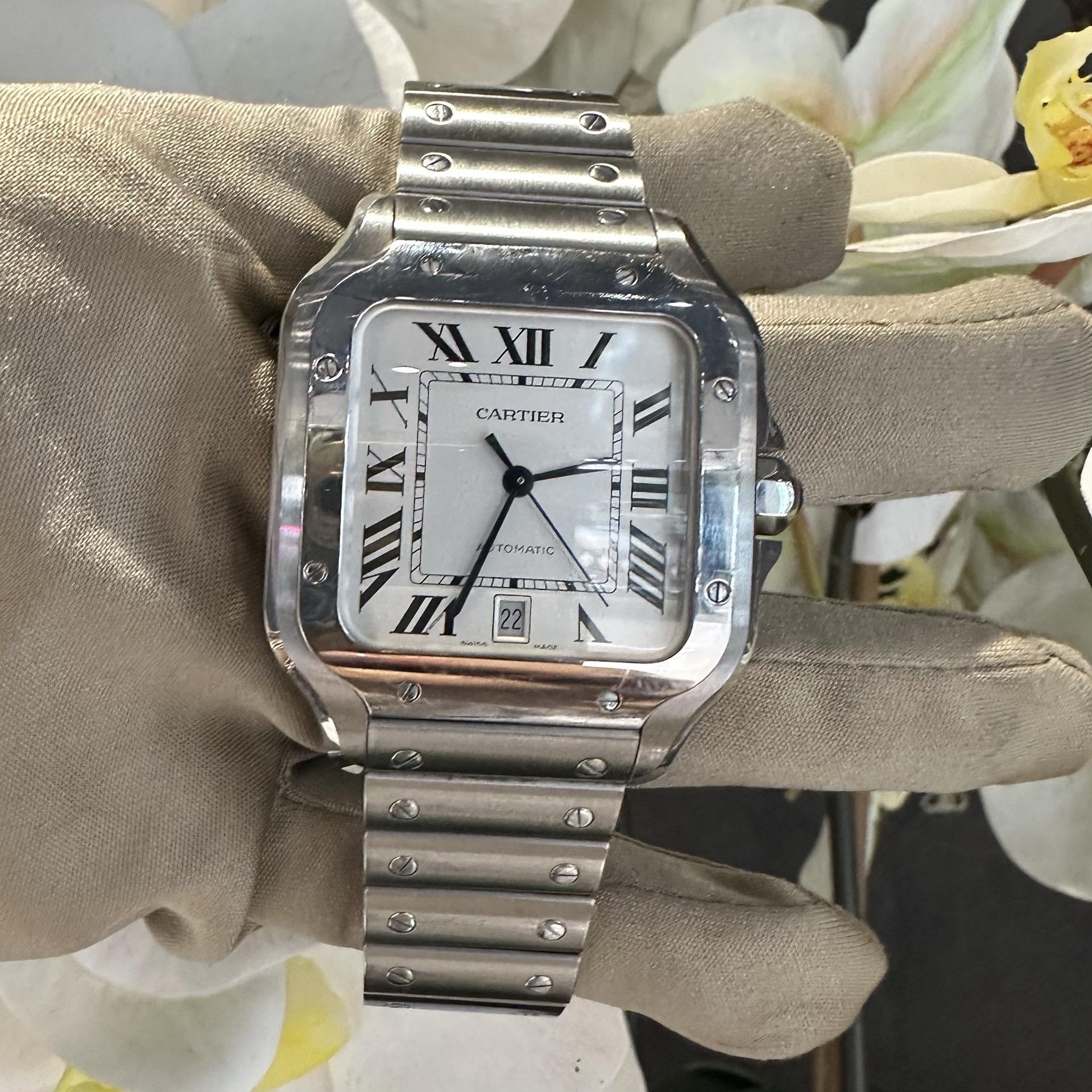 Brand: Cartier​​​​​​​
Model Name: Santos
Model Number: WSSA0018
Movement: Automatic
Case Size: 40 mm
Dial Color:  White
Metal: Stainless Steel
Hour Markers: Roman Numerals
Crystal: Sapphire Crystal
​​​​​​​Water Resistance: 100 m (10 ATM)
Year: