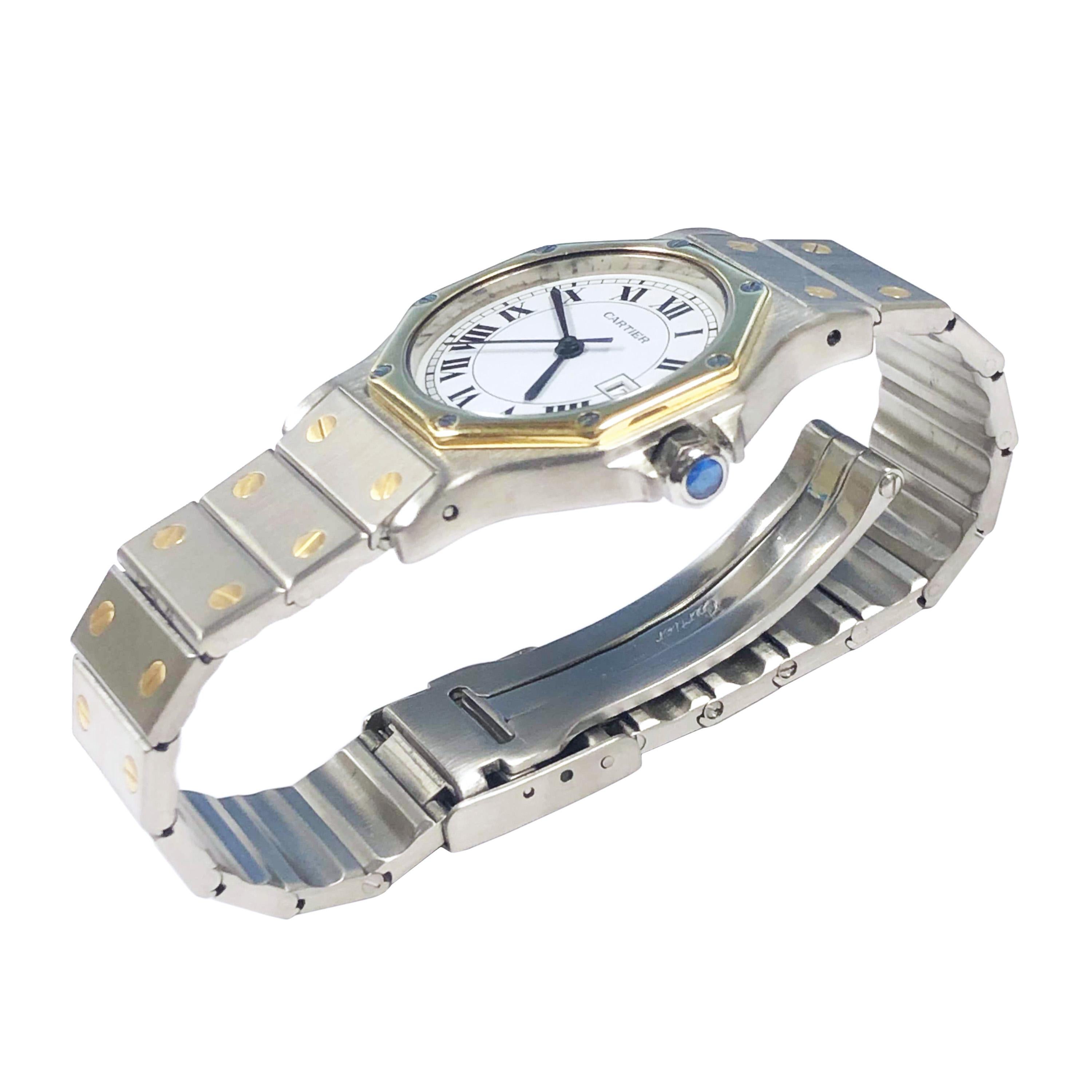 Circa 2000 Cartier Santos Mid Size Wrist watch, 37 X 31 MM Stainless Steel Water resistant case with an 18K yellow Gold Bezel, Quartz Movement, White dial with Black Roman Numerals, Calendar window at the 3 position, sweep seconds hand and a