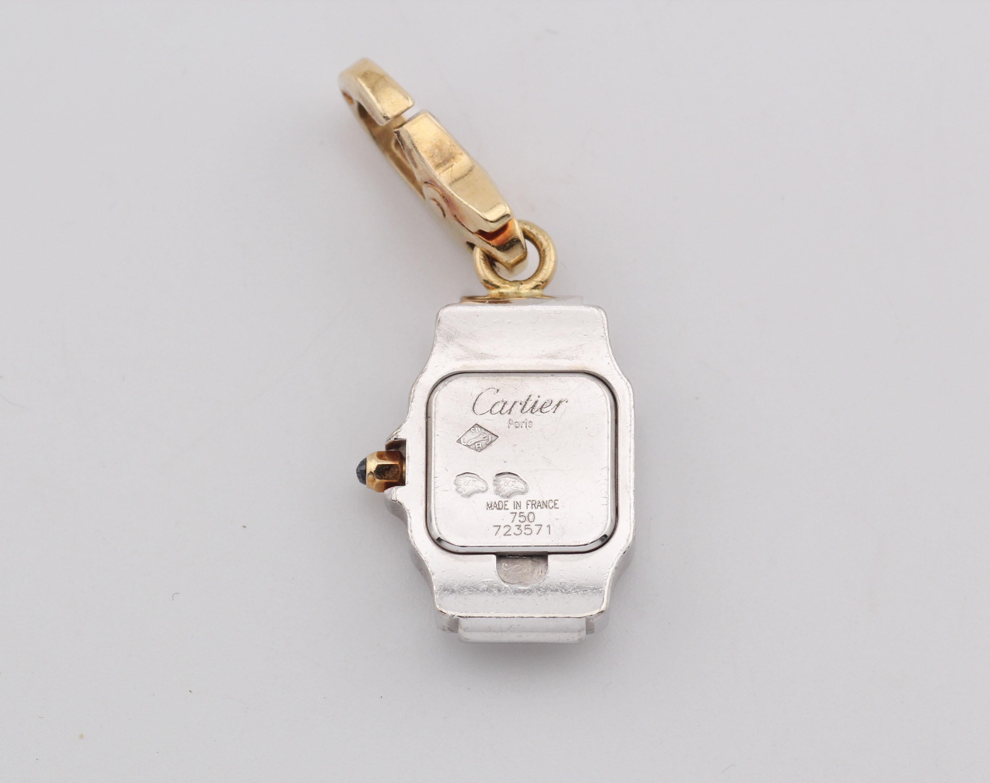 Cette breloque rare de Cartier est un hommage miniature à l'emblématique montre Santos de Cartier, entièrement réalisée en or 18 carats lumineux. Sculptée selon les mêmes lignes architecturales qui définissent la Santos - le boîtier carré adouci,