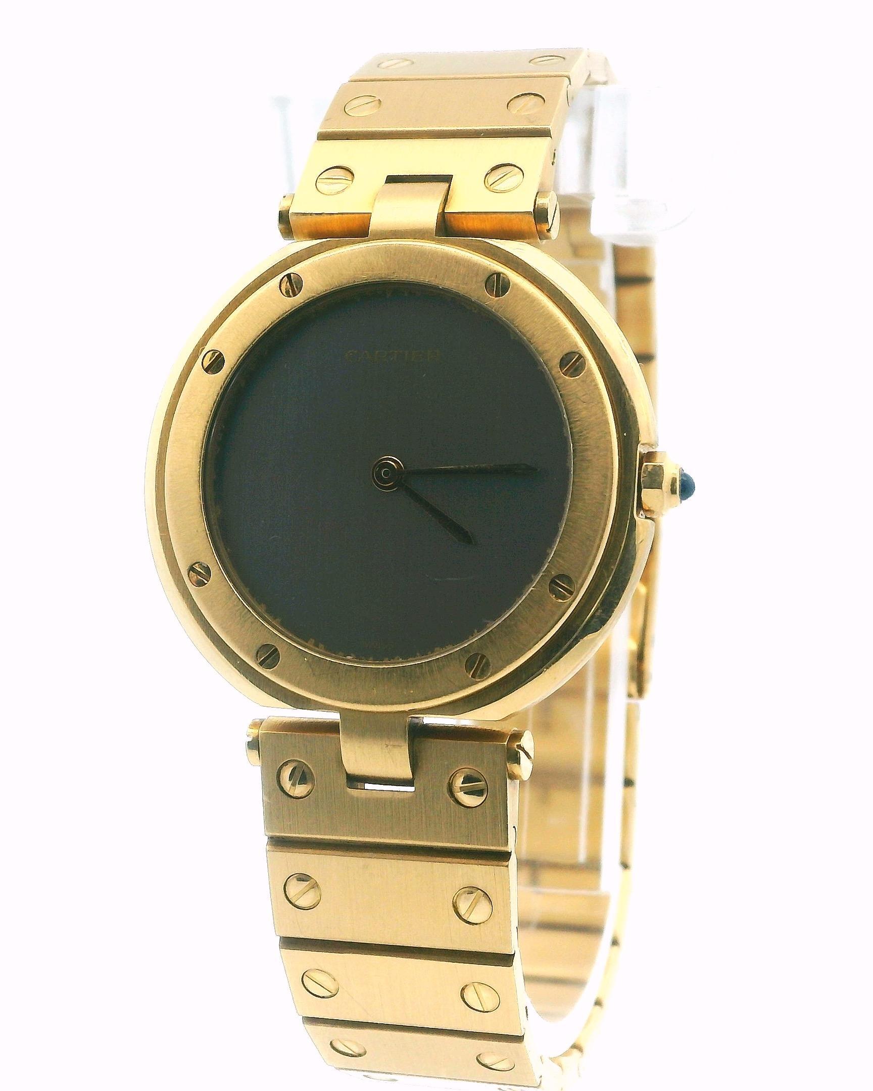 Cartier Vendôme Ladies Watch features a 32.5 mm case made of 18K yellow gold. It has an 18K yellow gold bezel and a unique ghost dial with gold hands. The watch comes with an 18K yellow gold bracelet that includes a fold-over clasp, fitting wrists
