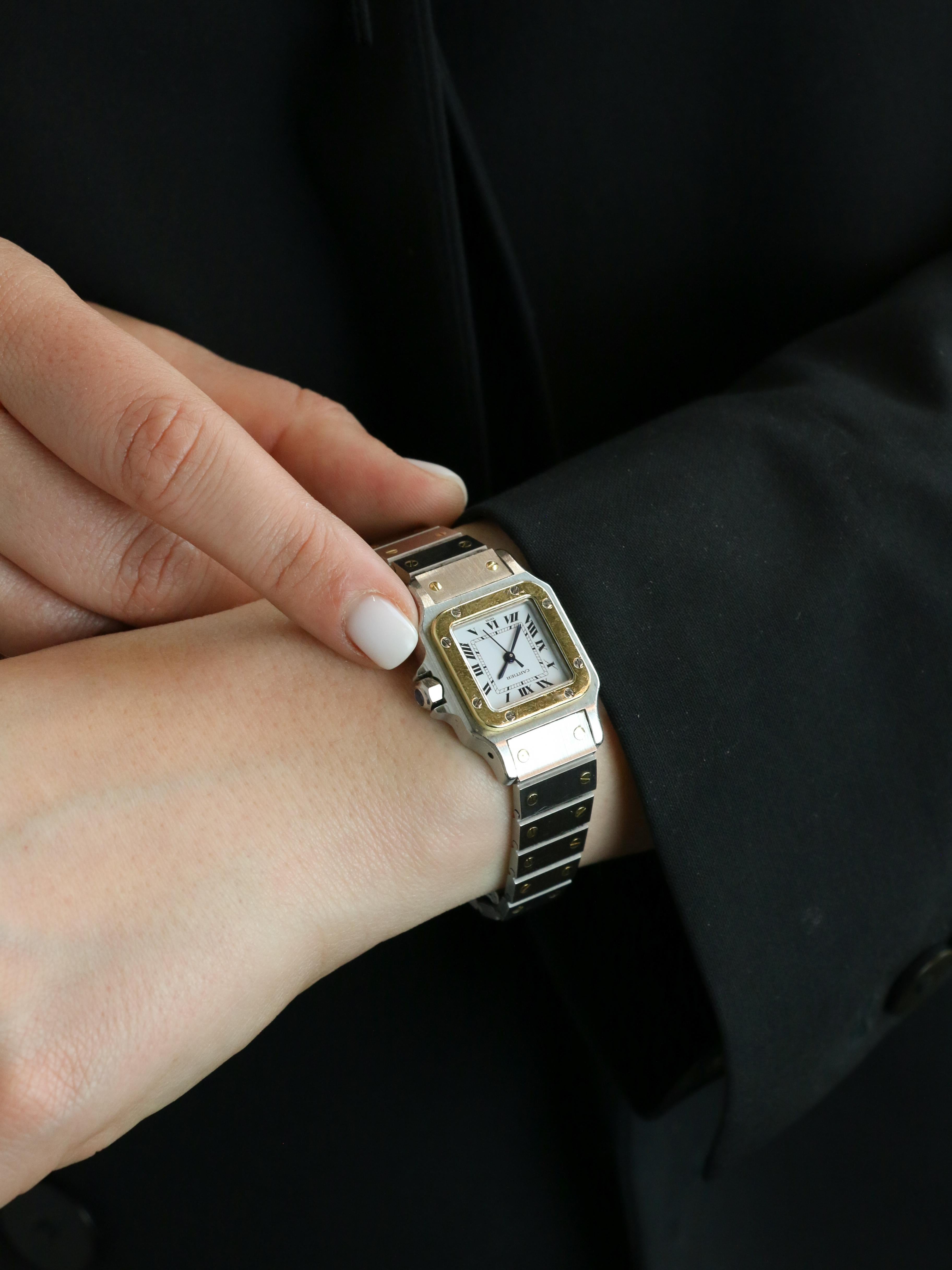Vintage CARTIER Uhr Modell Santos

CARTIER - Automatic Santos Damenuhr aus Stahl und 18K Gold (750°/°°) mit elegantem weißem Zifferblatt. Referenz 0902, aus den späten 1980er Jahren. Kompaktes Gehäuse von 24 mm (ohne Krone), geschützt durch ein