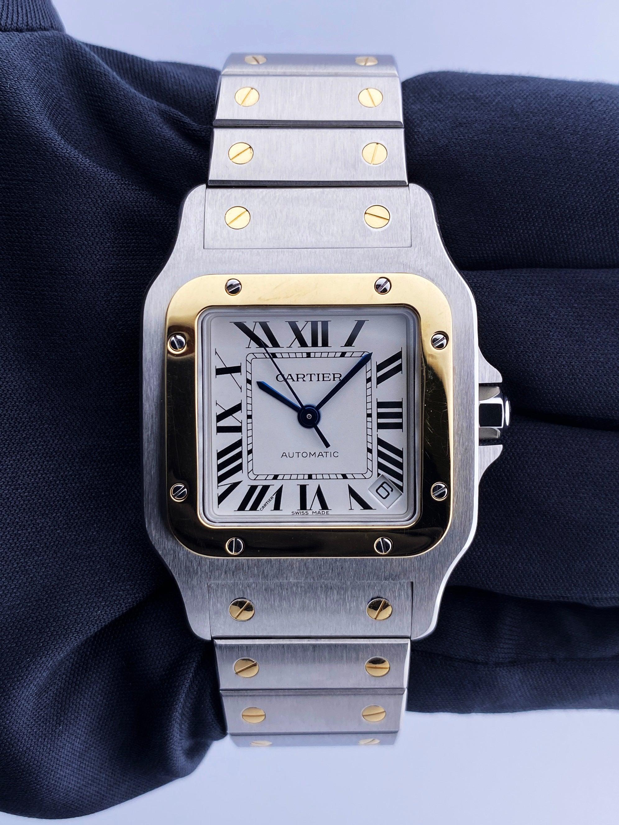 Cartier Santos 2823 Mens Watch. 32mm stainless steel case. 18K yellow gold bezel. White dial with blue steel hands Black Roman numeral hour markers. Minute markers around an inner dial. Date display between 4 and 5 o'clock position. 18K yellow gold