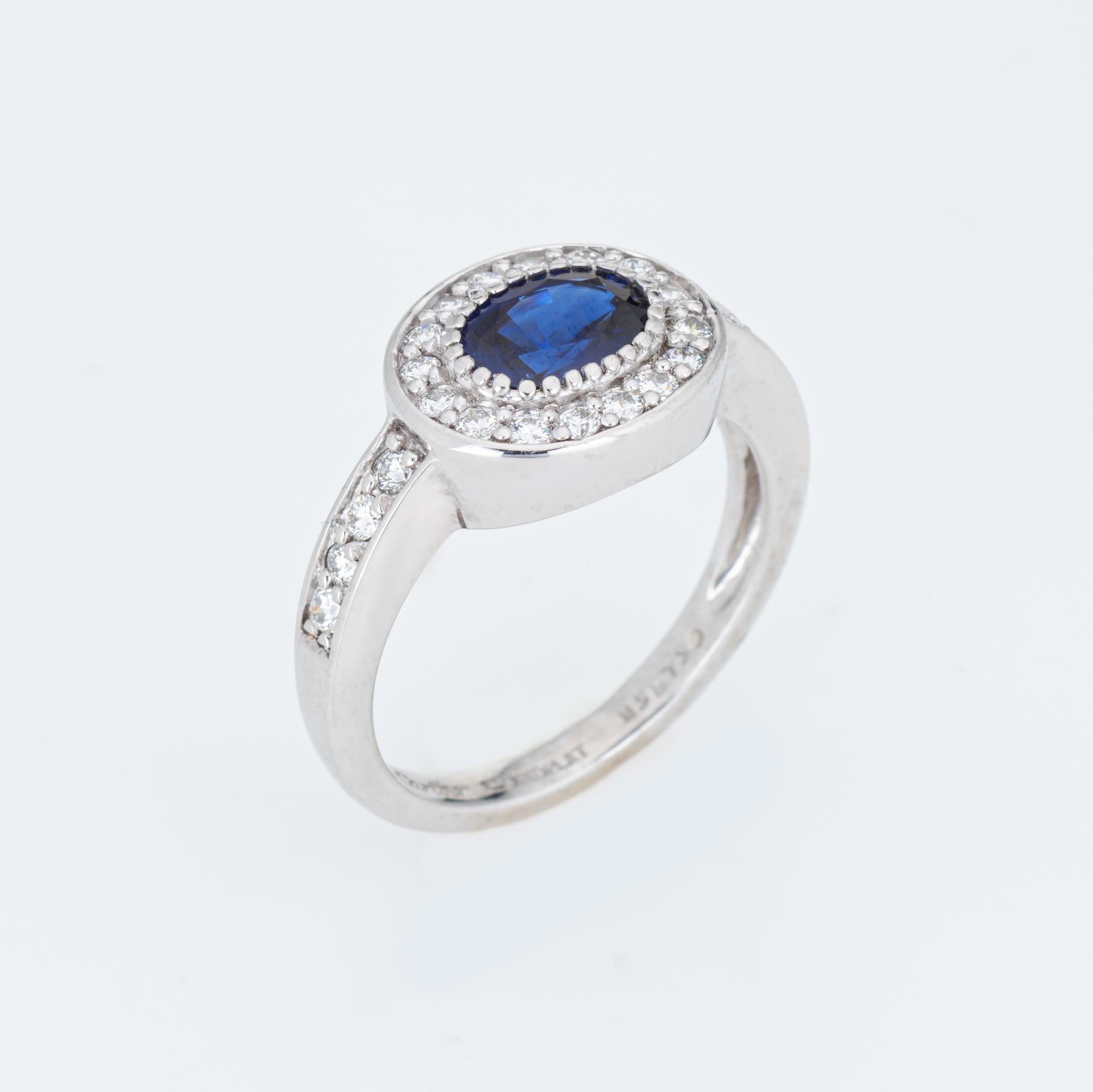 Pre-owned Cartier blue sapphire & diamond ring crafted in 900 platinum.  

Oval faceted blue sapphire measures 6mm x 4mm, accented with 24 estimated 0.01 carat diamonds. The total diamond weight is estimated at 0.24 carats (estimated at F-G color