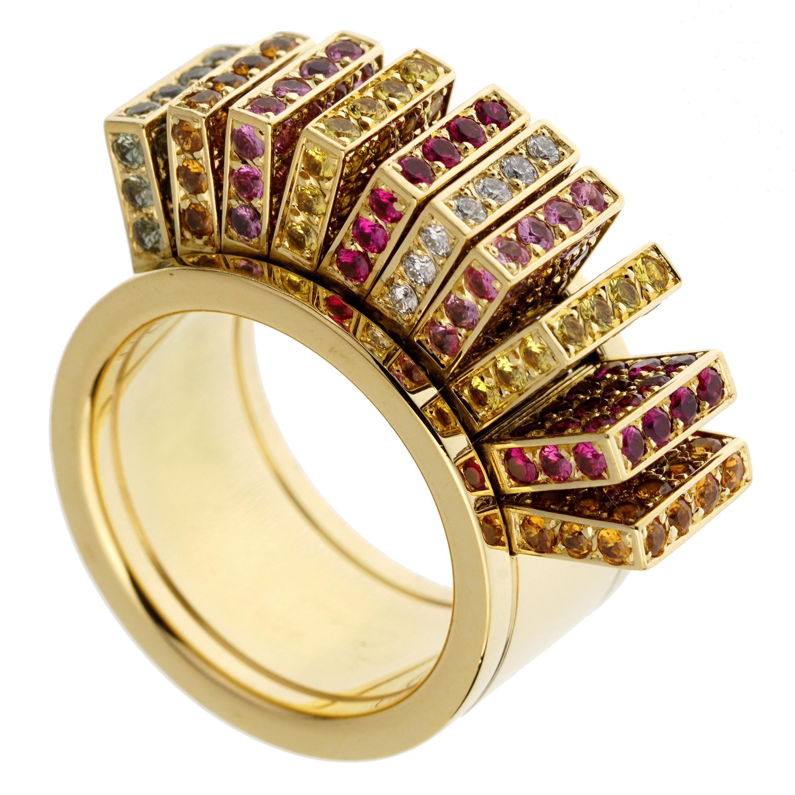 A fine cocktail ring Cartier Paris, the ring features moving panels each adorned with 34 sapphires of various colors. One panel is paved in diamonds. The heavy band is 10mm wide and measures a size 5. Full signed Cartier and numbered. Circa 2000.