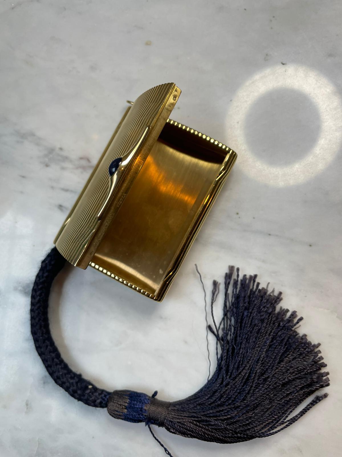 A Cartier sapphire set cigarette and lighter evening gold purse, circa 1930.

Originating from Paris circa 1930. This rare and unusual case is set with a cabochon sapphire as its thumb piece,  featuring a very typical design of the transitional age