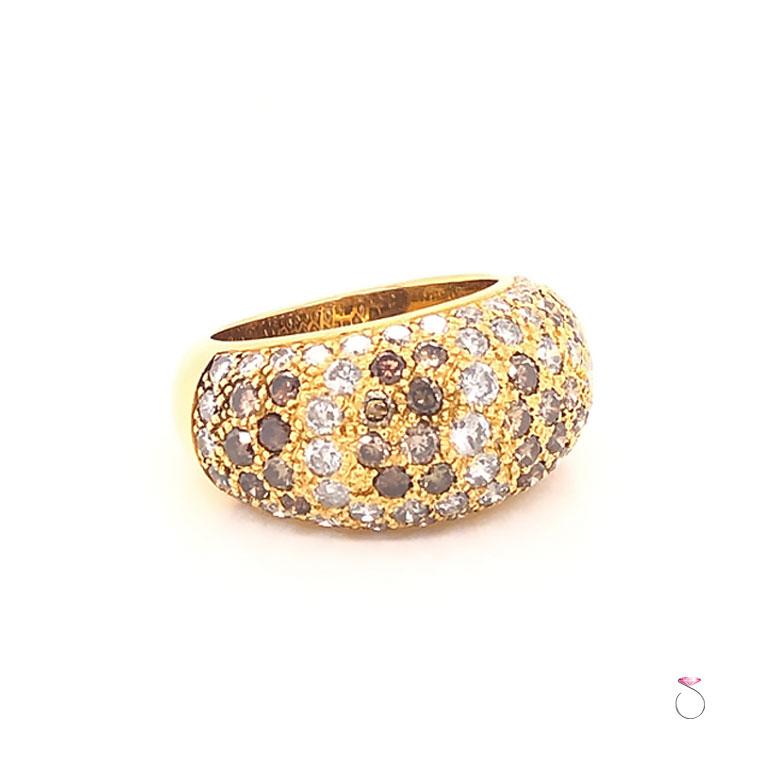 This Magnificent vintage Cartier ring from the 1999 Sauvage collection is just stunning. The large dome ring is crafted in 18K yellow gold and set with over three carats of white and natural brown diamonds. All the diamonds are pave' set. As usual