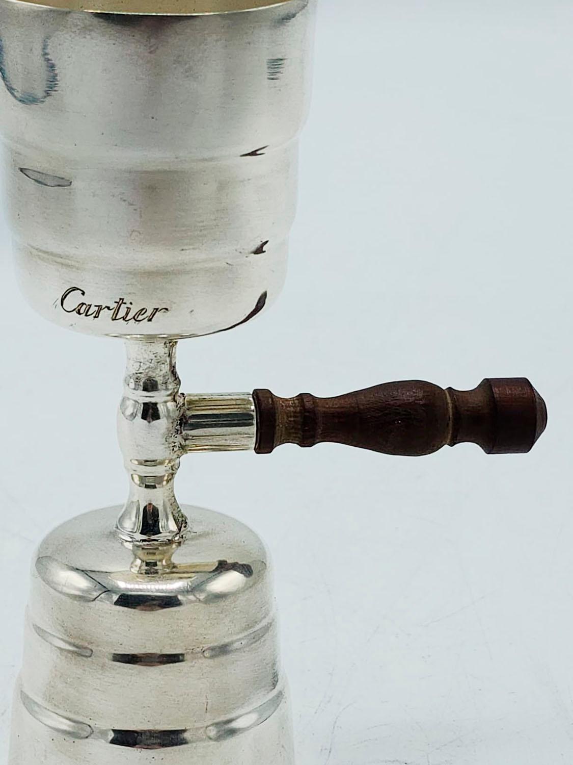 Cartier silver plated drinks measurer
with wooden handle carved with design

Measures:
Total height: 11.5 centimeters
Height of ounces: 4.5 and 4 centimeters
Diameter: 4 centimeters