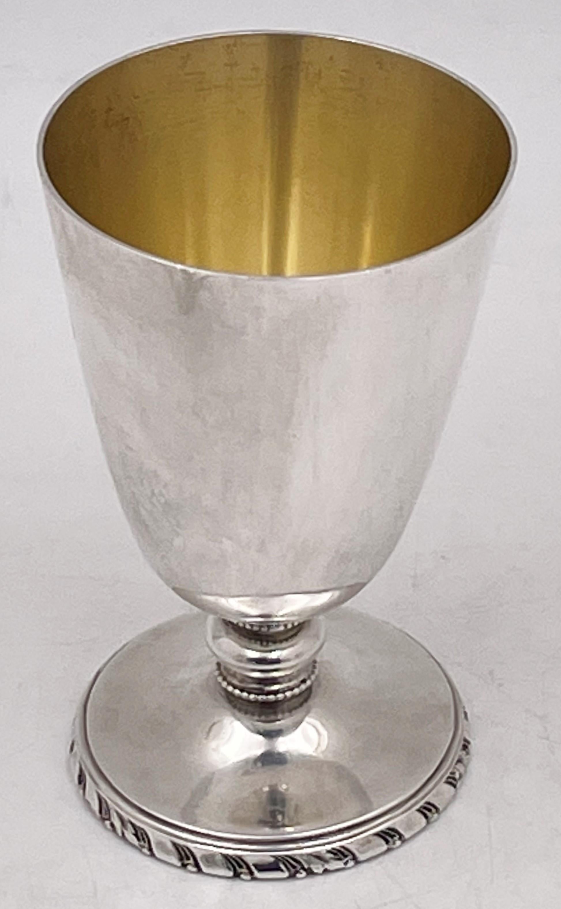 Cartier, set of 6 sterling silver Kiddush/ cordial cups in Mid-Century Modern style, with an elegant design, all of which have a faintly gilt interior. The base showcases stylized natural motifs while the stem has a beaded pattern. Each cup measures