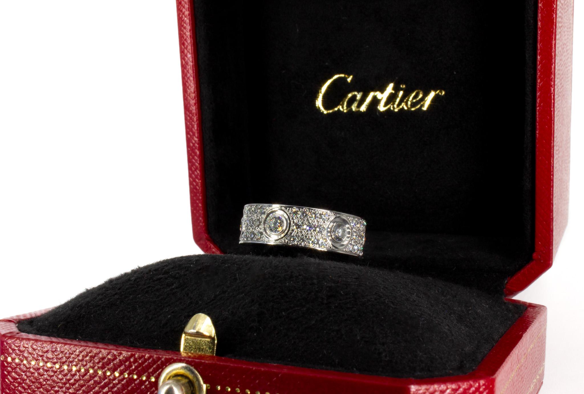 The Cartier LOVE Ring in white gold is a dazzling expression of timeless elegance and modern luxury. Expertly crafted in 18K white gold, this iconic design is adorned with 72 brilliant-cut pave diamonds, totaling 1.26 carats, that shimmer with