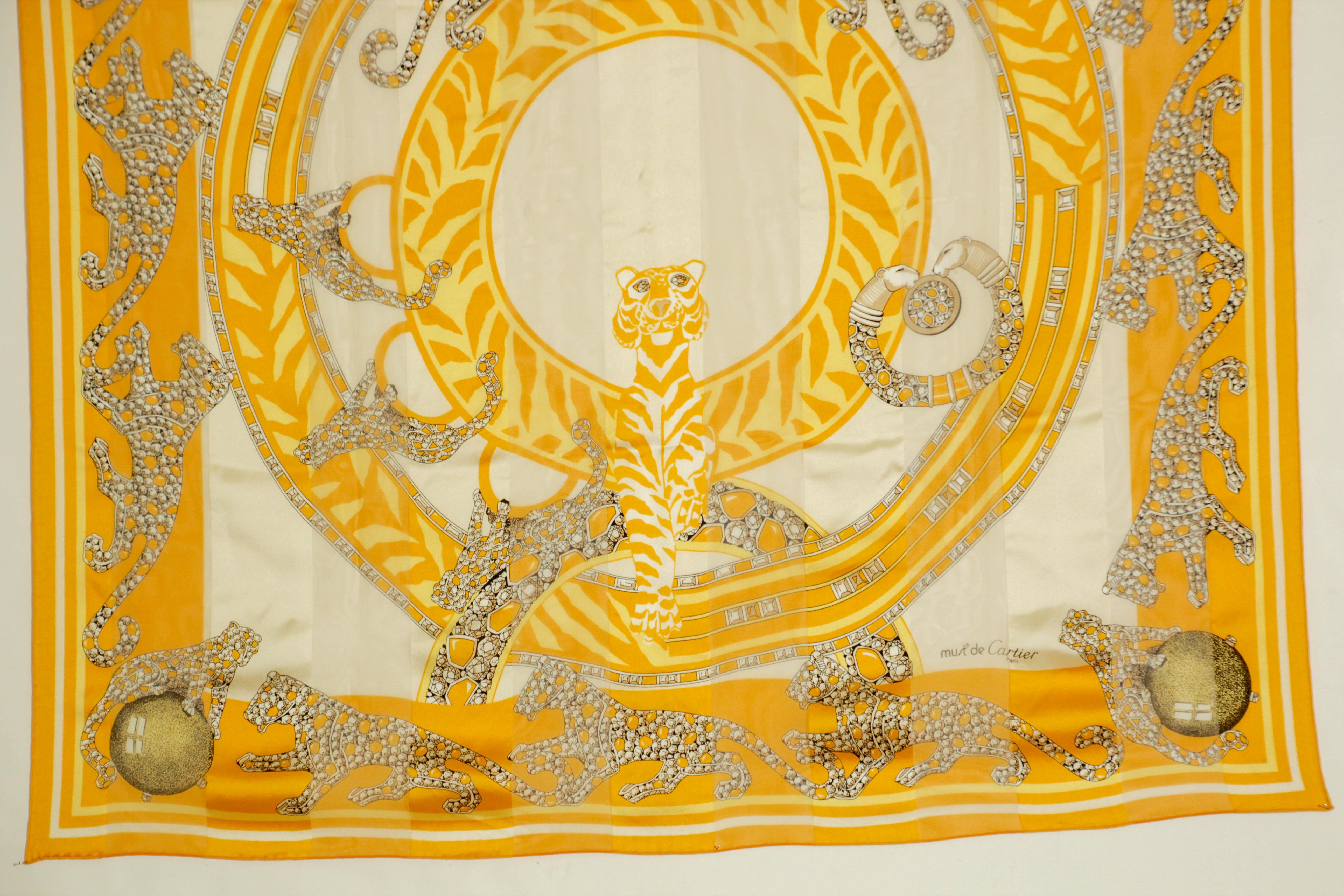 CARTIER in Box Elegant Silk Scarf Must de Cartier Paris France.
Les Must de Cartier Paris silk bright yellow scarf with precious Panthere jewels.
Yellow gold background with the rare Must de Cartier silk scarf with the motif 