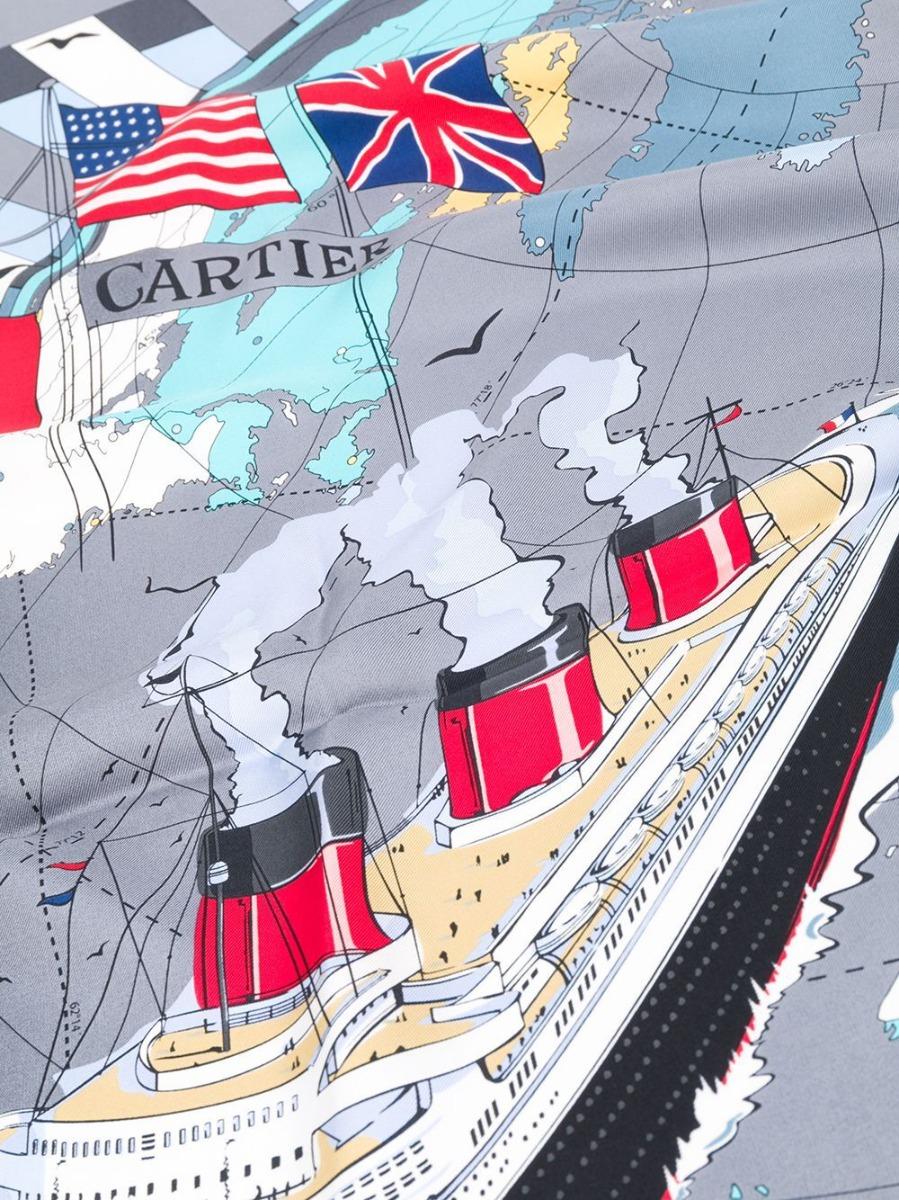 Silk scarf by Cartier featuring an all-over print representing the globe and a cruise ship as well as the British, American and French flags. Brand-new.
