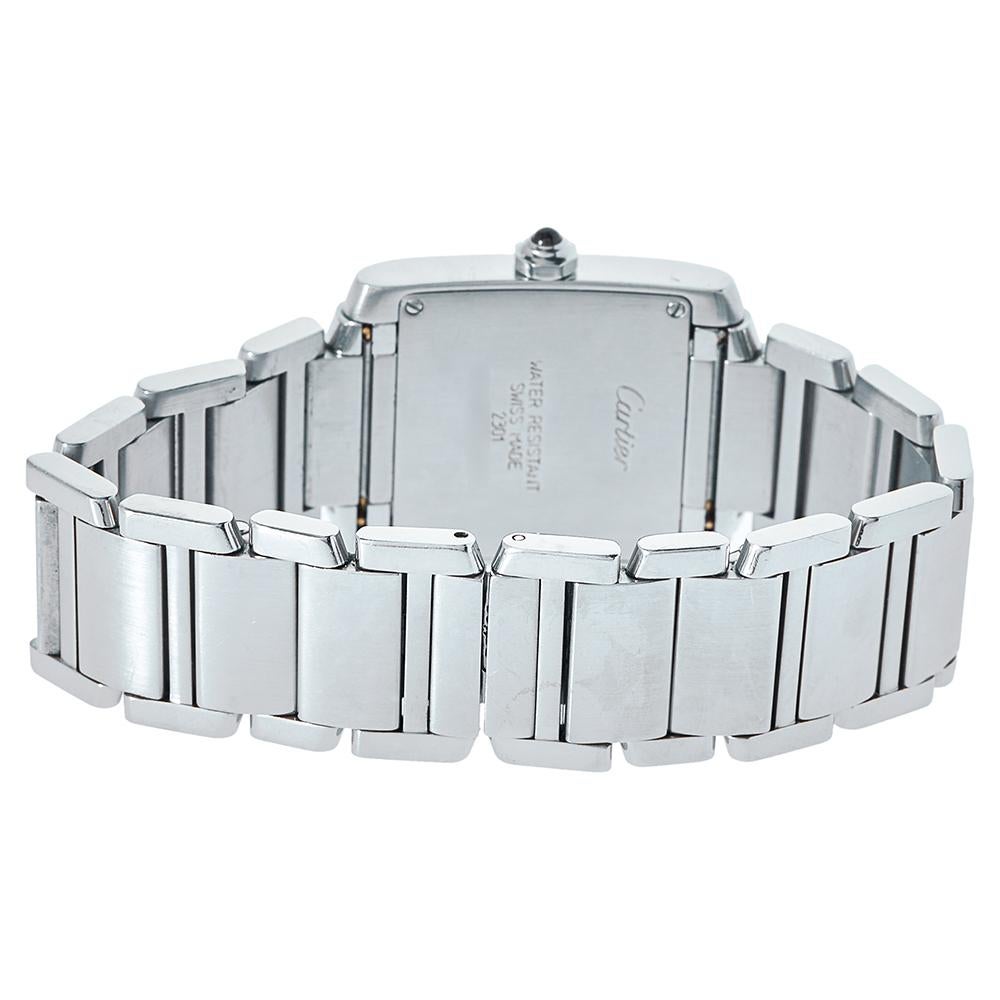 This Cartier Tank Francaise watch is presented in stainless steel. It features a square dial set with Roman numeral hour markers, sword-shaped hands in blue, and a discreet signature at VII. This Quartz watch is finished with a beautiful crown and a