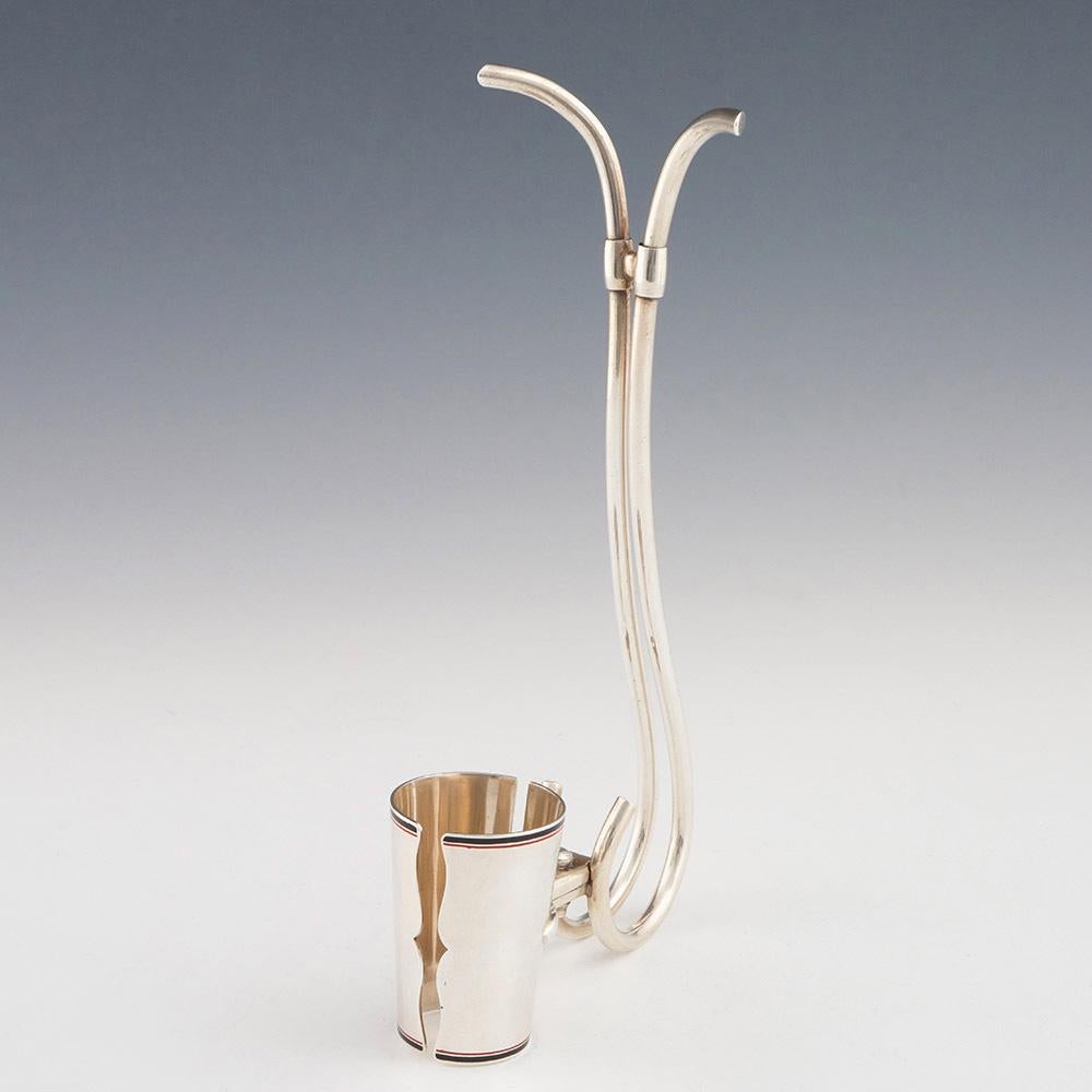 Heading : Cartier silver wine bottle holder with enamel detail
Date : Early 20th century
Origin : France
Decoration : Adjustable wine bottle holder with black and red enamel bands. Marked Cartier STERLING 923 – 1000
Size :  23.5cm x 11.5cm
Condition