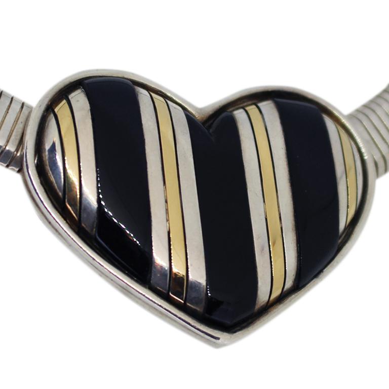 Circa 1970 Cartier Sterling Silver 18K yellow Gold and Onyx inlay Heart Necklace, the Heart measures 2 X 1 1/2 inches and is attached to a 16 inch flexible snake chain measuring 3/8 inch wide and 1/8 inch thick. The chain has an opening locking