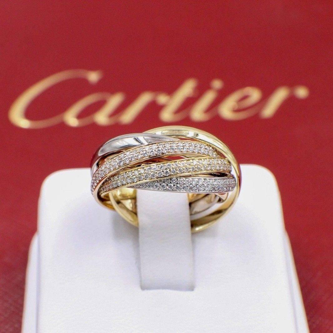 TRINITY De Cartier

Style: Trinity Classic
Serial Number: #30082C
Metal: !8Kt Yellow & White & Rose Gold
Serial: #30082C
Size: 57 - US 8
Total Carat Weight: 1.48 TCW Round Brilliant Diamonds F Color / VS-VVS Clarity
Hallmark: 