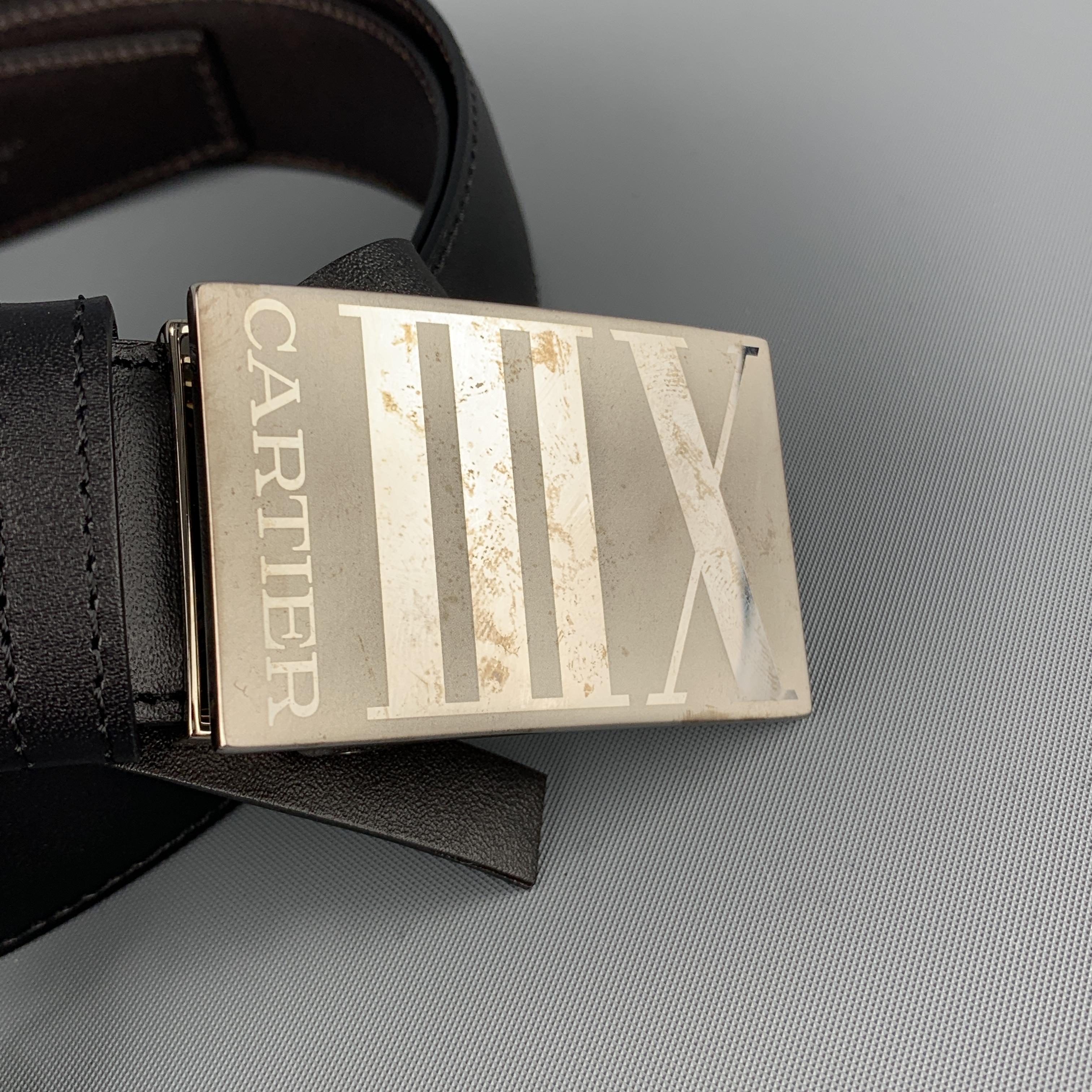 Vintage CARTIER belt features a reversible black and dark brown leather strap with a silver tone XIII buckle. Tarnishing on buckle from storage. As-is. Includes box and card. Made in France.
 
New with Defects.
Marked: (no size)
 
Length: 50