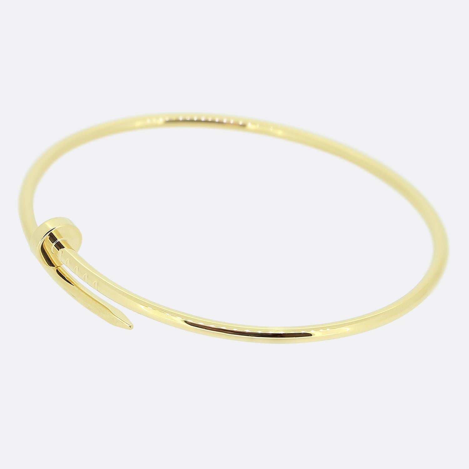 Here we have an 18ct yellow gold bracelet from the luxury jewellery house of Cartier. The particular piece forms part of the world renowned 'Juste un Clou' collection and showcases a wrap-around nail design. This is the small model which allows the
