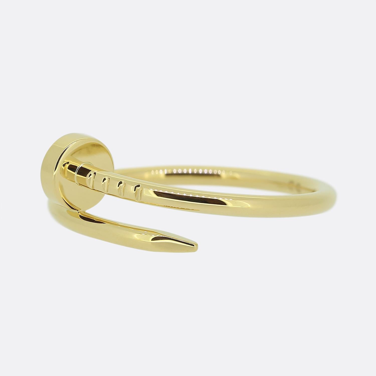 Here we have an excellently crafted 18ct yellow gold ring from the world renowned jewellery house of Cartier. This piece forms part of their iconic 'Juste un Clou' collection and showcases a wrap-around nail design. This is the small/thin model with