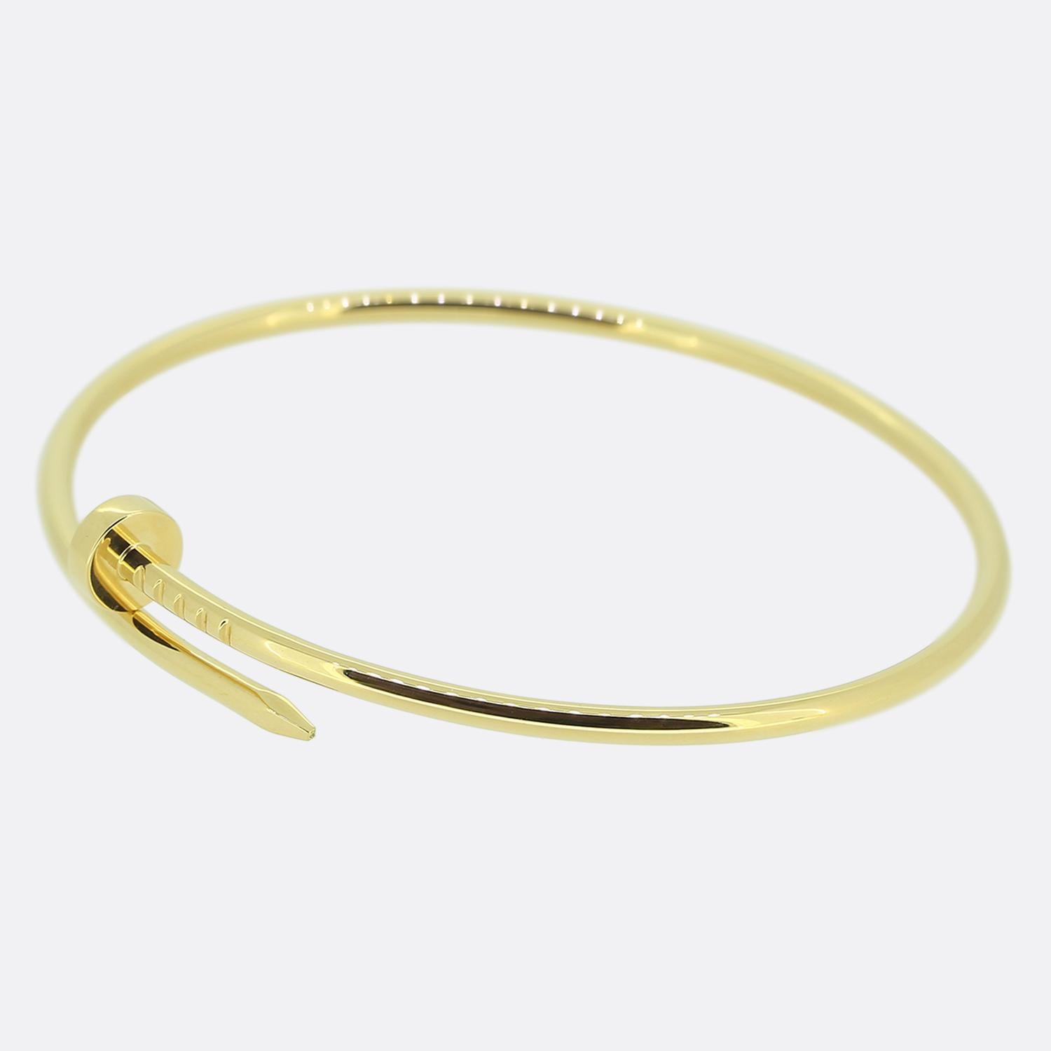 Here we have an 18ct yellow gold bangle from the world renowned luxury jewellery house of Cartier. This piece forms part of their iconic Juste un Clou collection and showcases a wrap around nail design. This is the small model which can slipped on