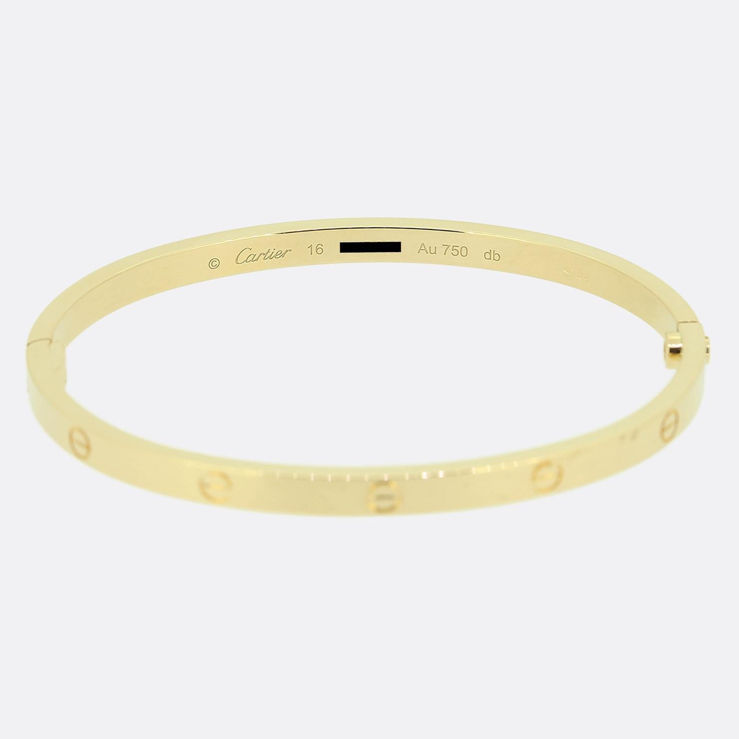 Here we have an 18ct yellow gold bangle from the world renowned luxury jewellery house of Cartier. This bangle forms part of the LOVE collection and features the iconic screw motif around the entire outer edge. This is the slimmer/thin model with a