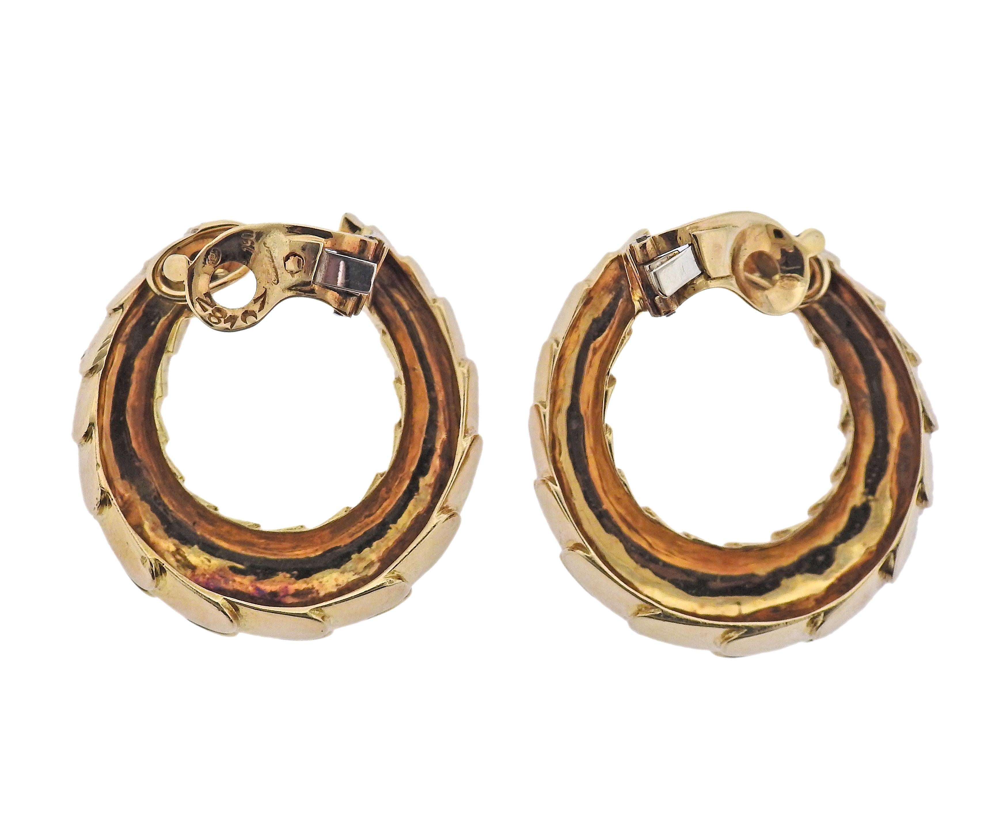 Pair of large 18k gold snake skin design hoop earrings by Cartier. Earrings measure 35mm x 32mm. Marked: Cartier, 750, French mark. Weight - 37.5 grams.