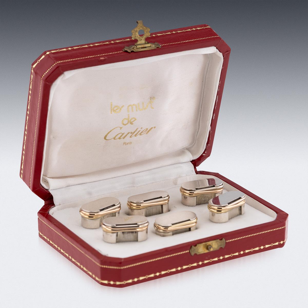 Cartier set of six menu holders in solid silver decorated with tri-color gold bands, signed Cartier Paris, inventory numbered. Maker’s mark and assay mark for silver, made in France, accompanied in the original les must de Cartier Paris