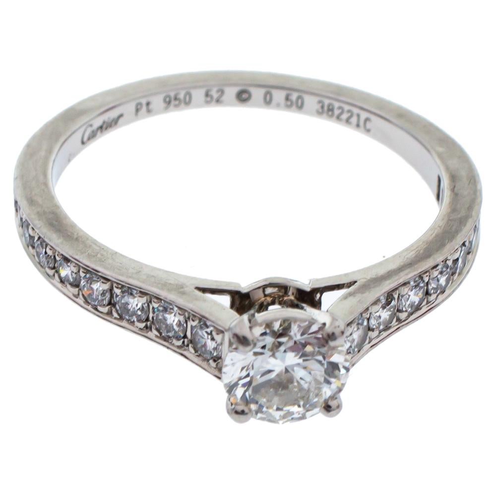 Looking for an ideal ring. Well, this ring from the house of Cartier is something that will bring a smile to you every time you look at it. Crafted in platinum, this sleek ring is centered with a dazzling solitaire diamond. Encased in a branded