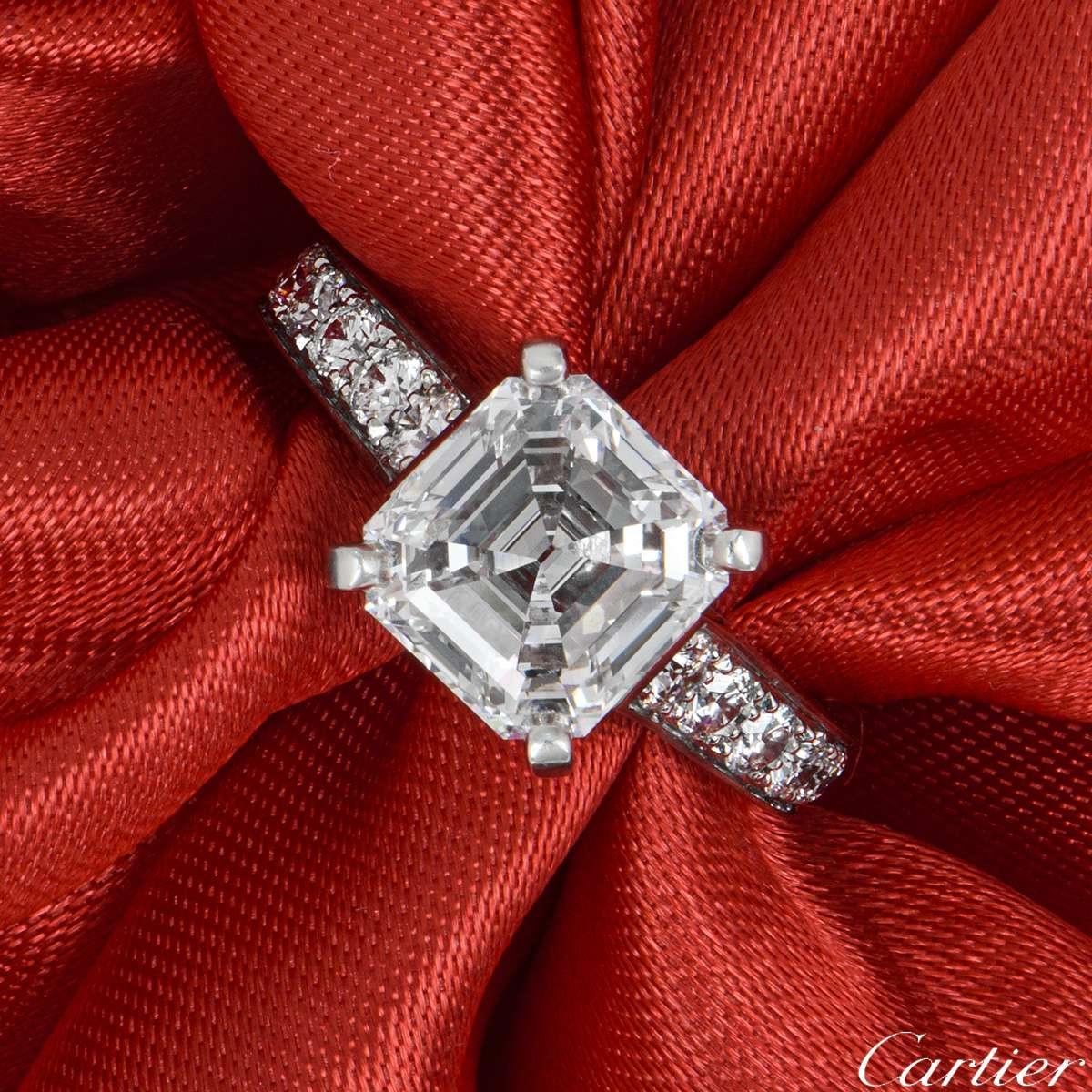 An exquisite diamond ring from the Solitaire 1895 collection by Cartier. The ring is set to the centre with a 2.76ct asscher cut diamond, D colour and IF clarity (Internally Flawless). There are 18 round brilliant cut diamonds set to the shoulders,