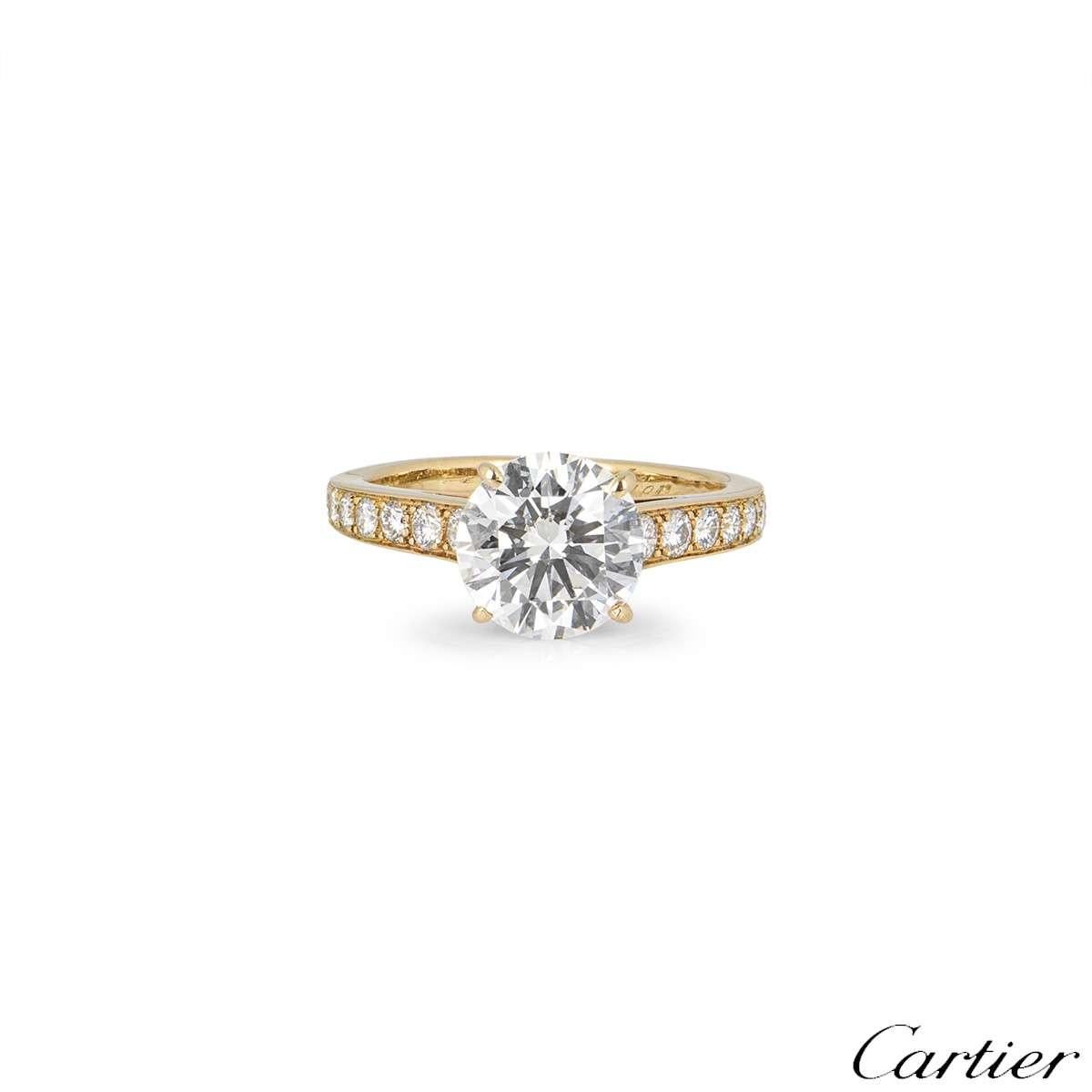 A beautiful 18k yellow gold diamond ring from the Solitaire 1895 collection by Cartier. The ring is set to the centre with a 2.02ct round brilliant cut diamond, D colour and VS1 in clarity. The ring has tapered diamond set shoulders totalling