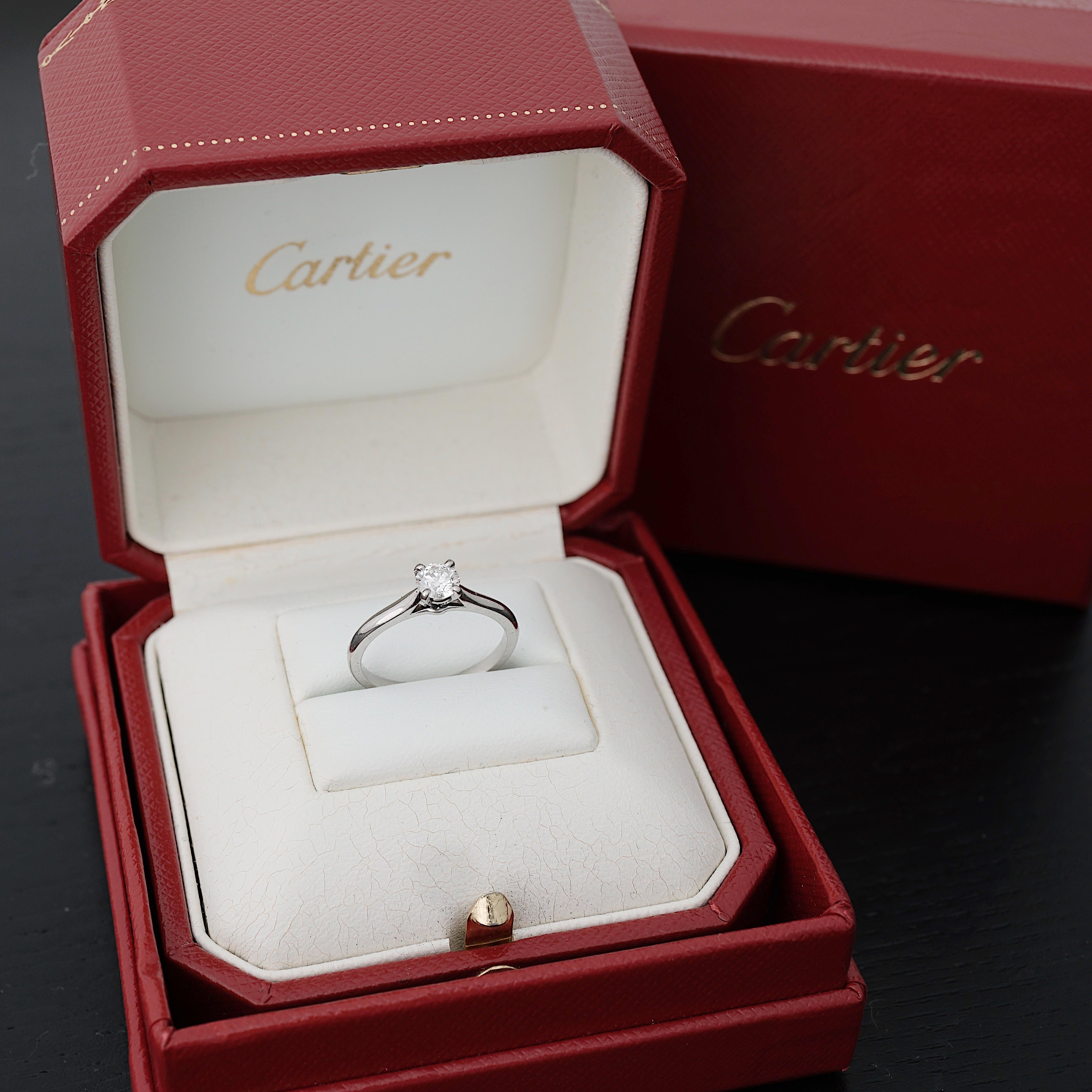 Cartier, Solitaire 1895,
Round Brilliant Cut
GIA certified 0,35 Carat, F Color and IF Clarity and Triple X quality.
Mounted in Platinum 950/1000.
Signed Cartier, and numbered. Size 50 (US 5.5).
GIA number inscribed, report N° 2121027636
Comes in its