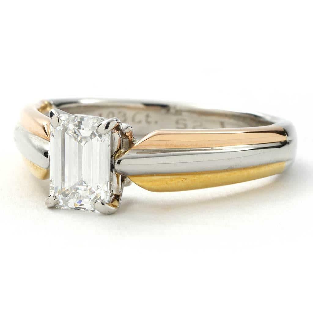 Retired Cartier Trinity Collection engagement ring. The ring is a size 7.5 (US), made of platinum and 18K yellow gold, and weighs 4.3 DWT (approx. 6.69 grams). It also has one emerald E-color, VS2-clarity diamond weighing 1.03 CT.